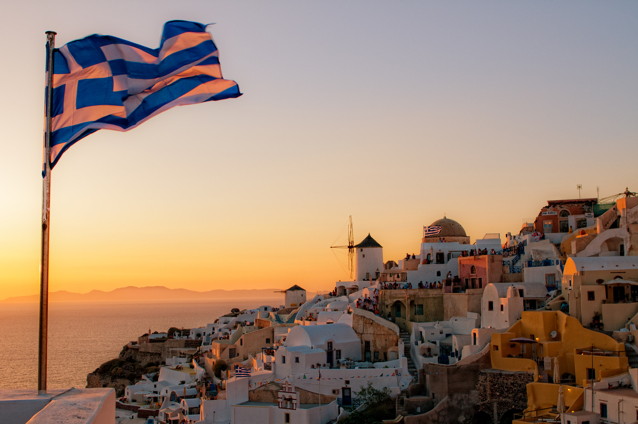 Nikon D300S + Nikon AF-S Nikkor 28mm F1.8G sample photo. Oia and the flag photography