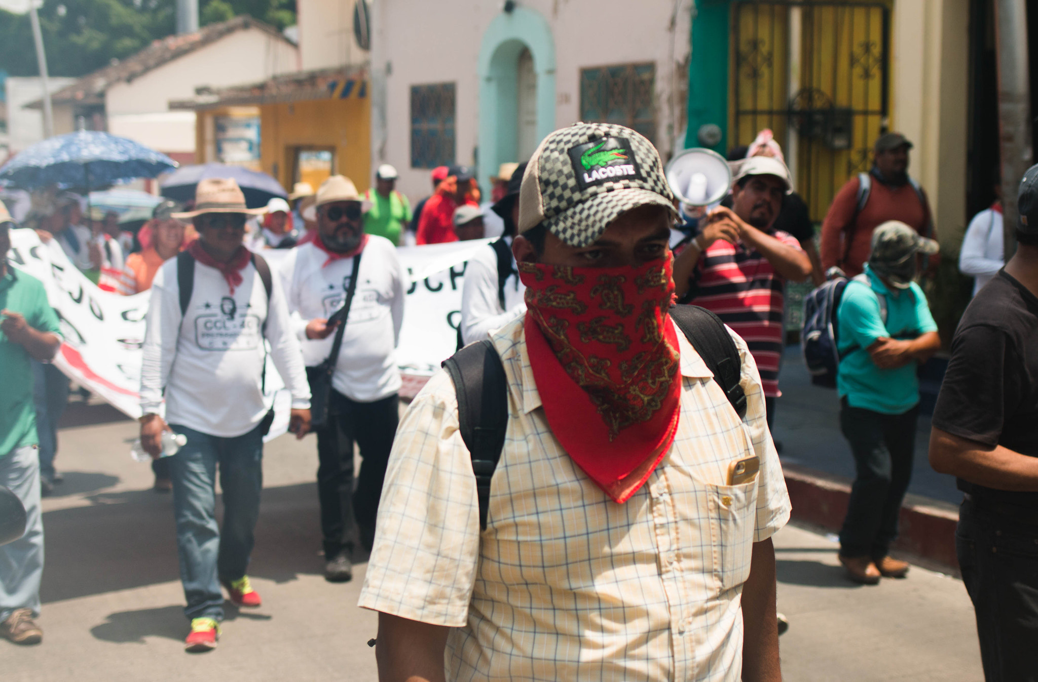Canon EOS 70D + Canon EF 35mm F2 IS USM sample photo. Protester during a fit of anger in the street photography
