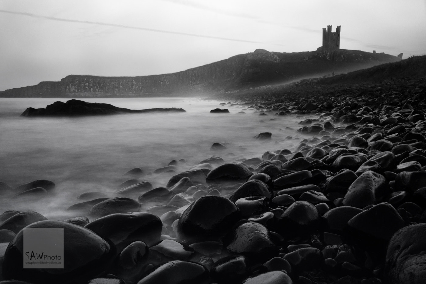 Nikon AF Nikkor 24-85mm F2.8-4D IF sample photo. Sea fret rolling in at dunstanburgh castle photography