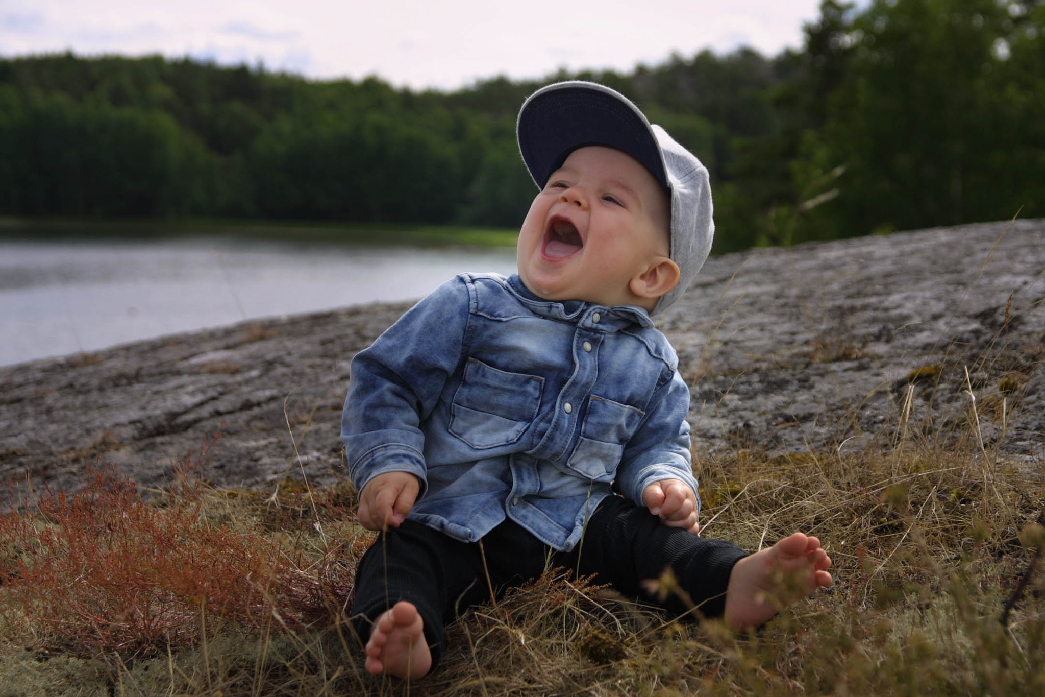 Canon EOS D30 + Sigma 17-70mm F2.8-4 DC Macro OS HSM sample photo. Baby on rock laughing photography