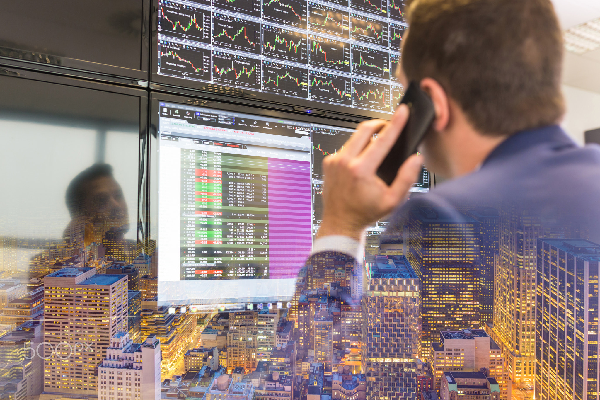 Stock trader looking at computer screens.