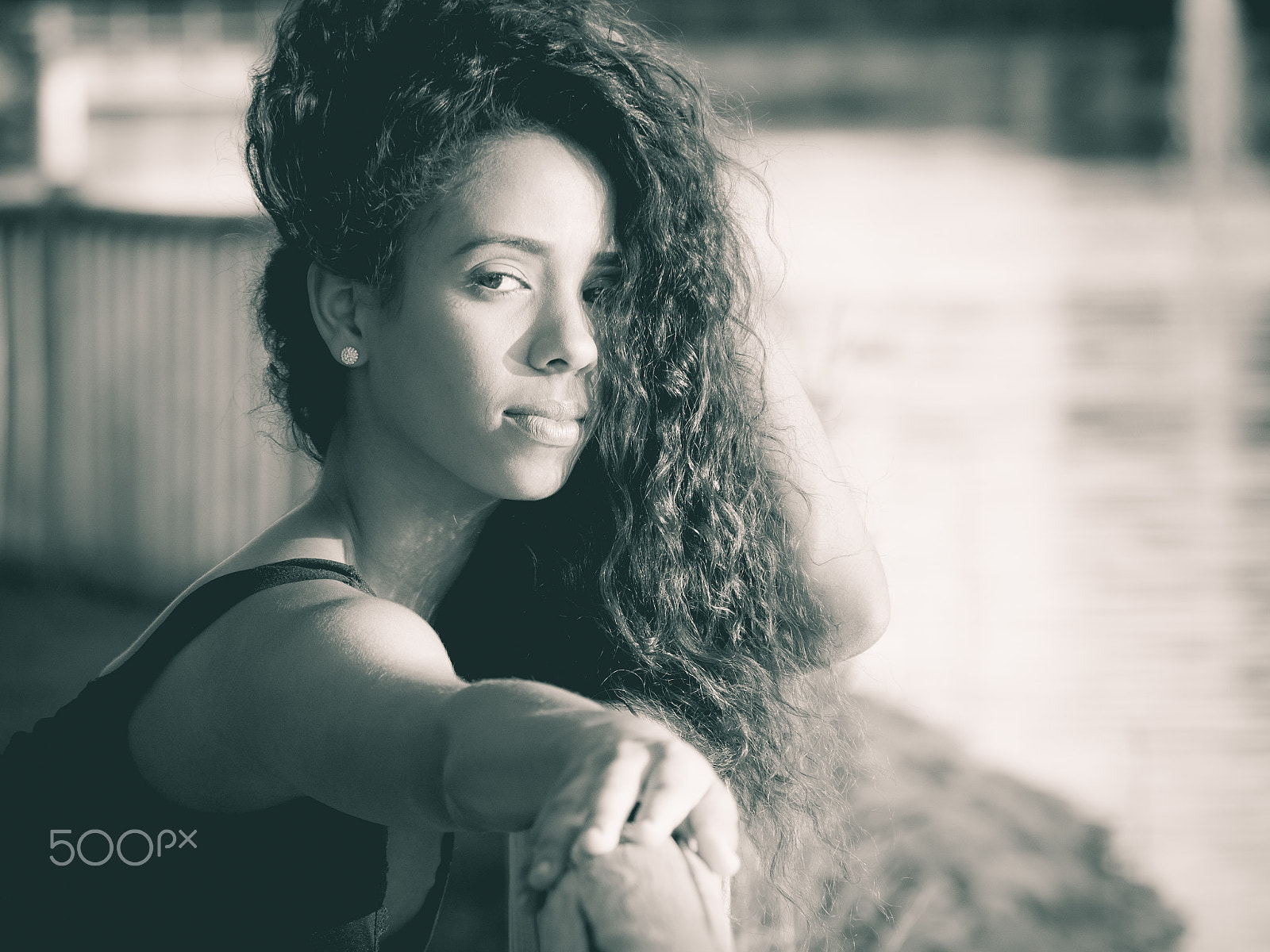 Panasonic Lumix DMC-GH3 sample photo. Latin woman looking at camera while touching her hair monochrome photography