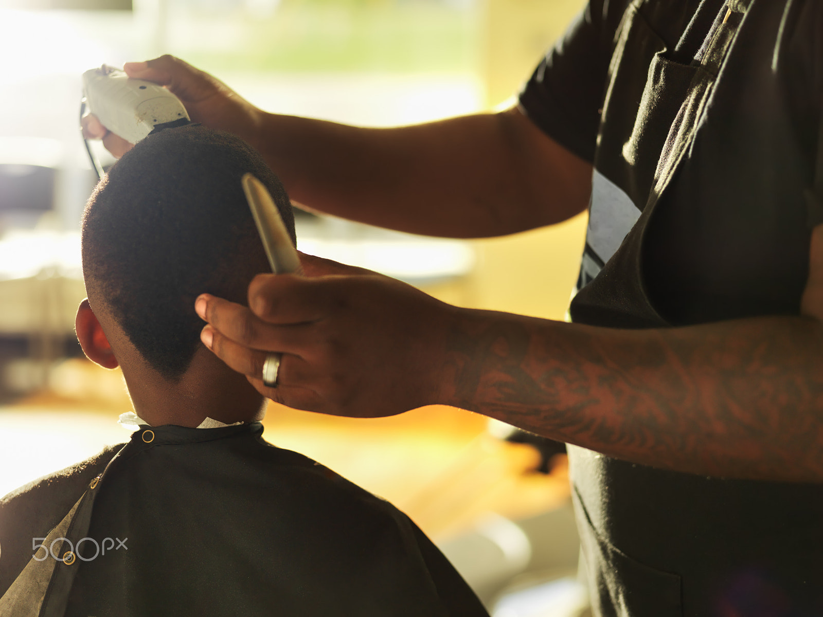 Hasselblad H3DII-39 sample photo. Little african boy having hair styled by barber photography
