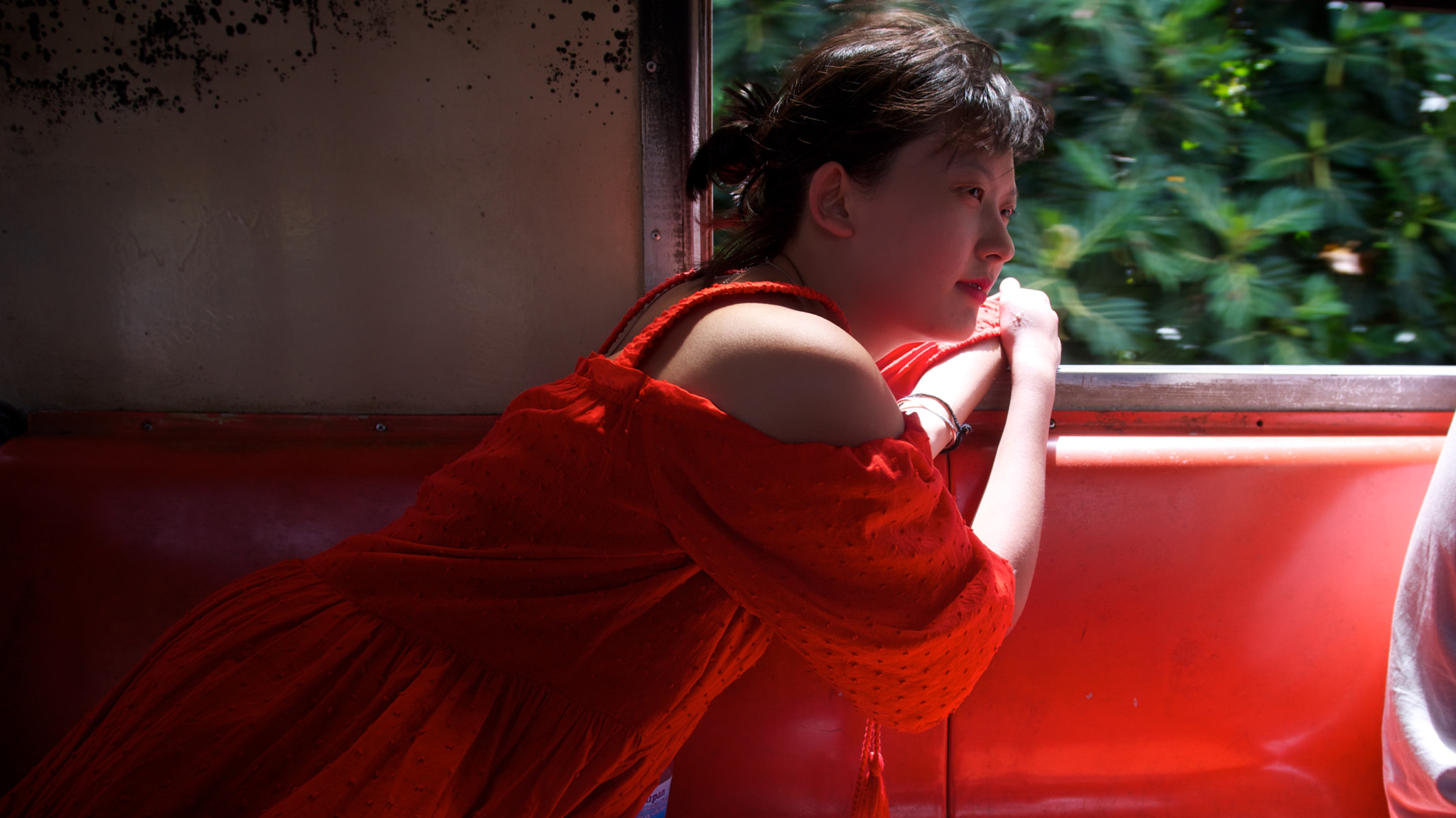 Pentax K-5 sample photo. Red skirt girl on train photography
