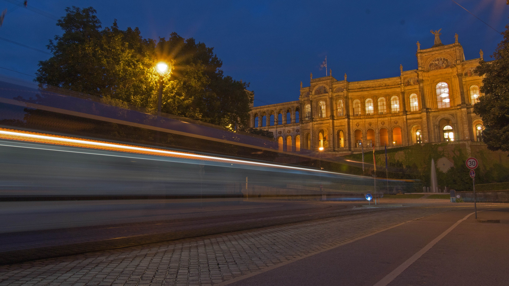 Sony ILCA-77M2 sample photo. The ghost tram passes under the building photography