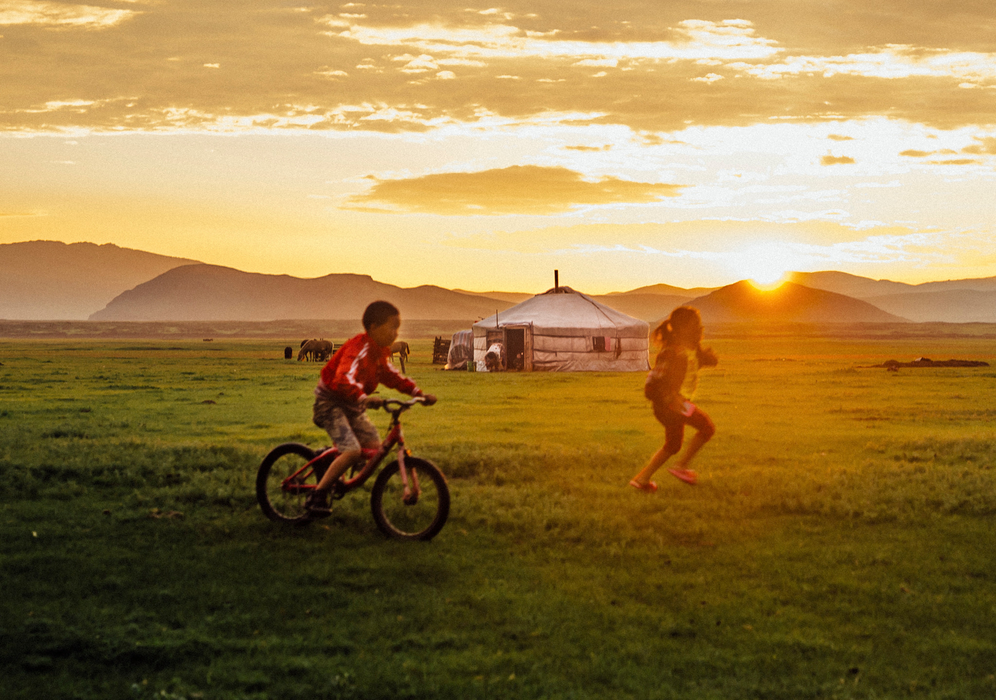 ZEISS Milvus 50mm F1.4 sample photo. Kids playing in front of the family yurt photography