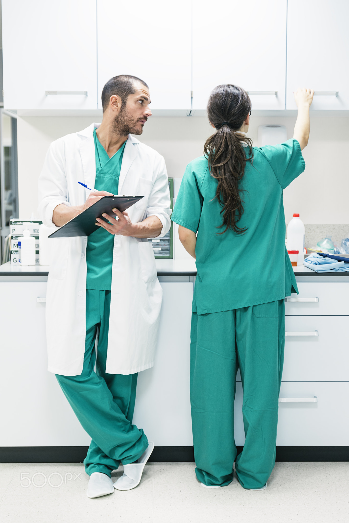 Doctor and nurse examining report of patient