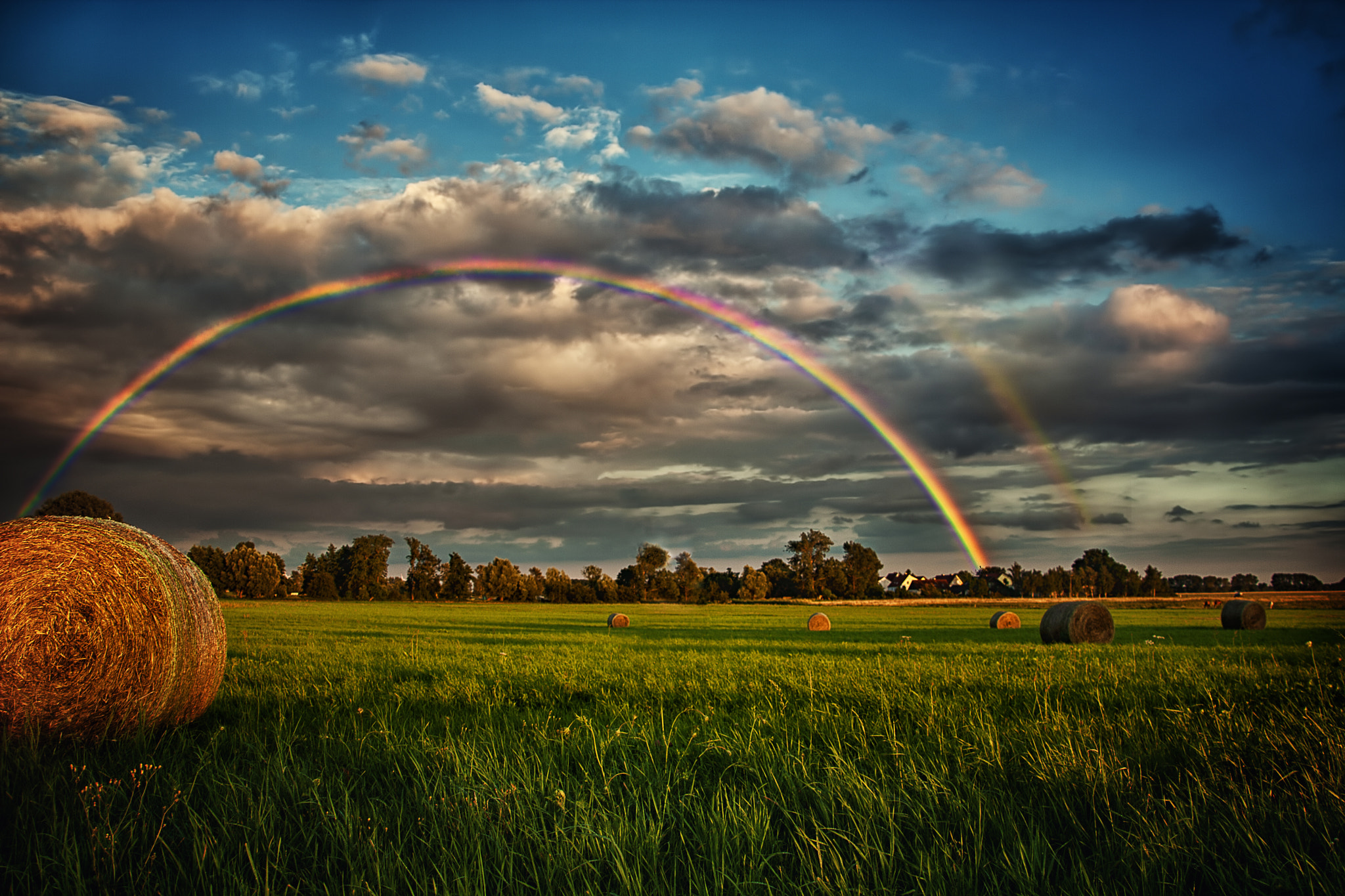 Canon EOS 1000D (EOS Digital Rebel XS / EOS Kiss F) sample photo. Rainbow behind village photography