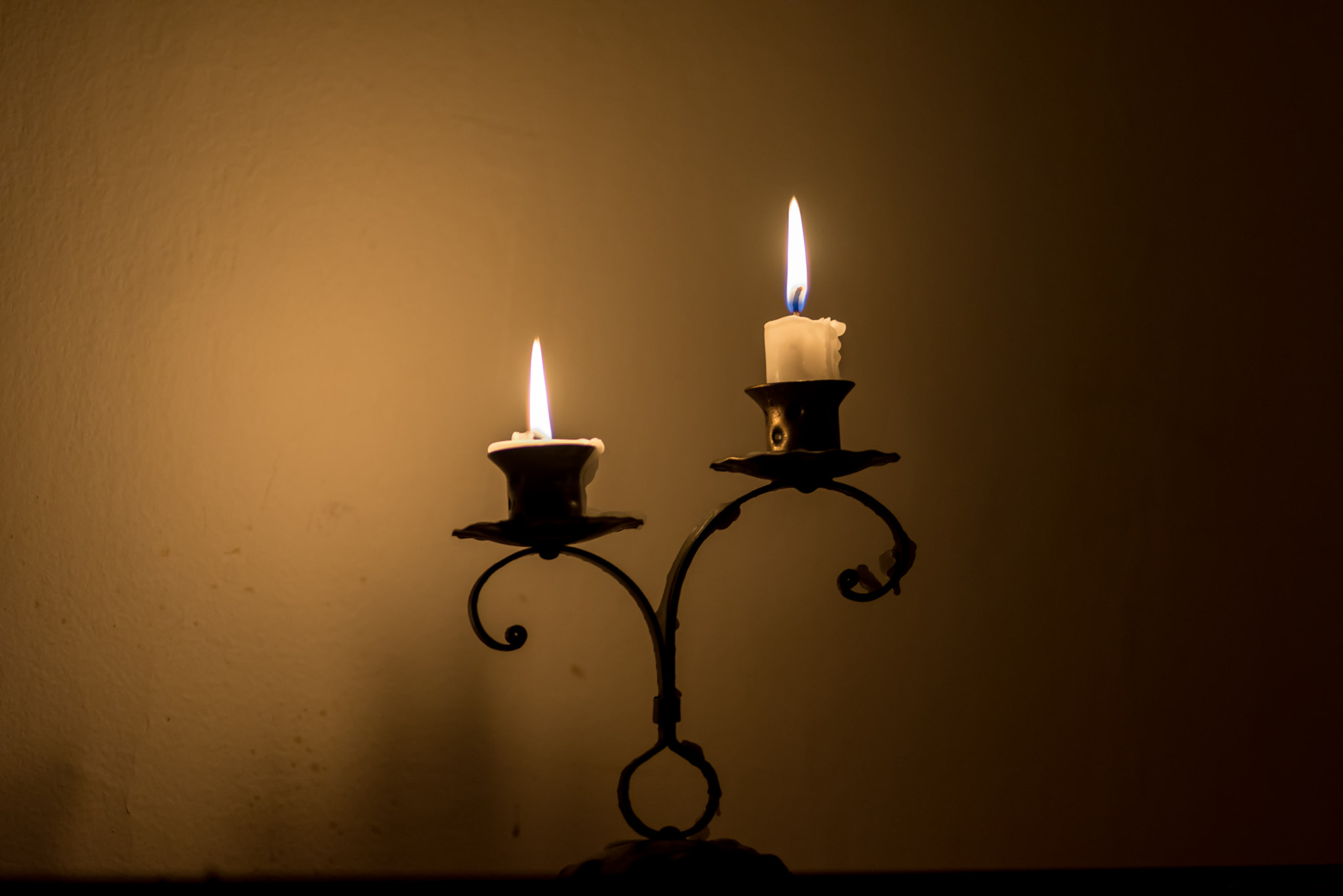 Nikon D610 + AF Nikkor 180mm f/2.8 IF-ED sample photo. Two small candles on holder over melted wax, in dark photography