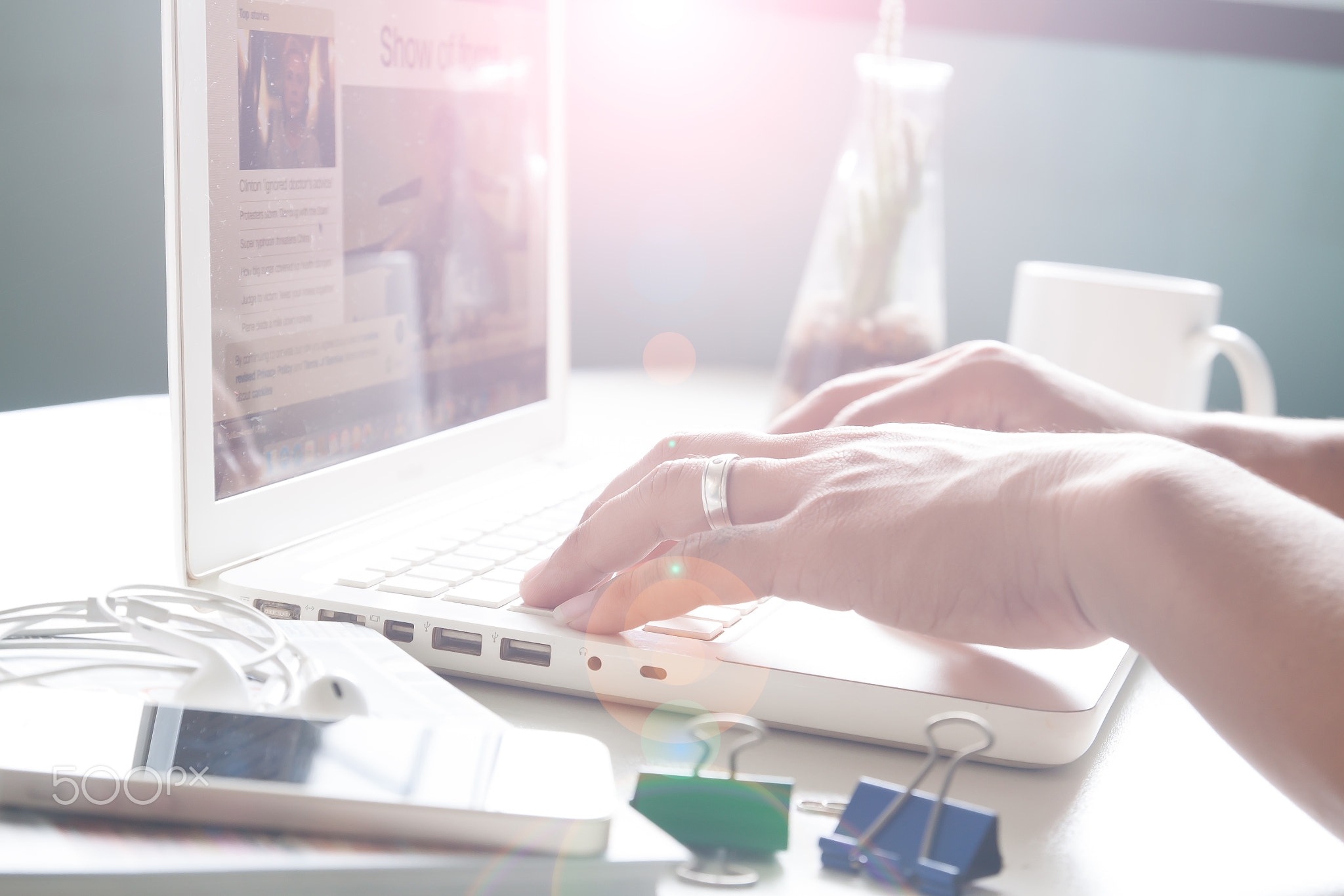 Man's hands using laptop for online news