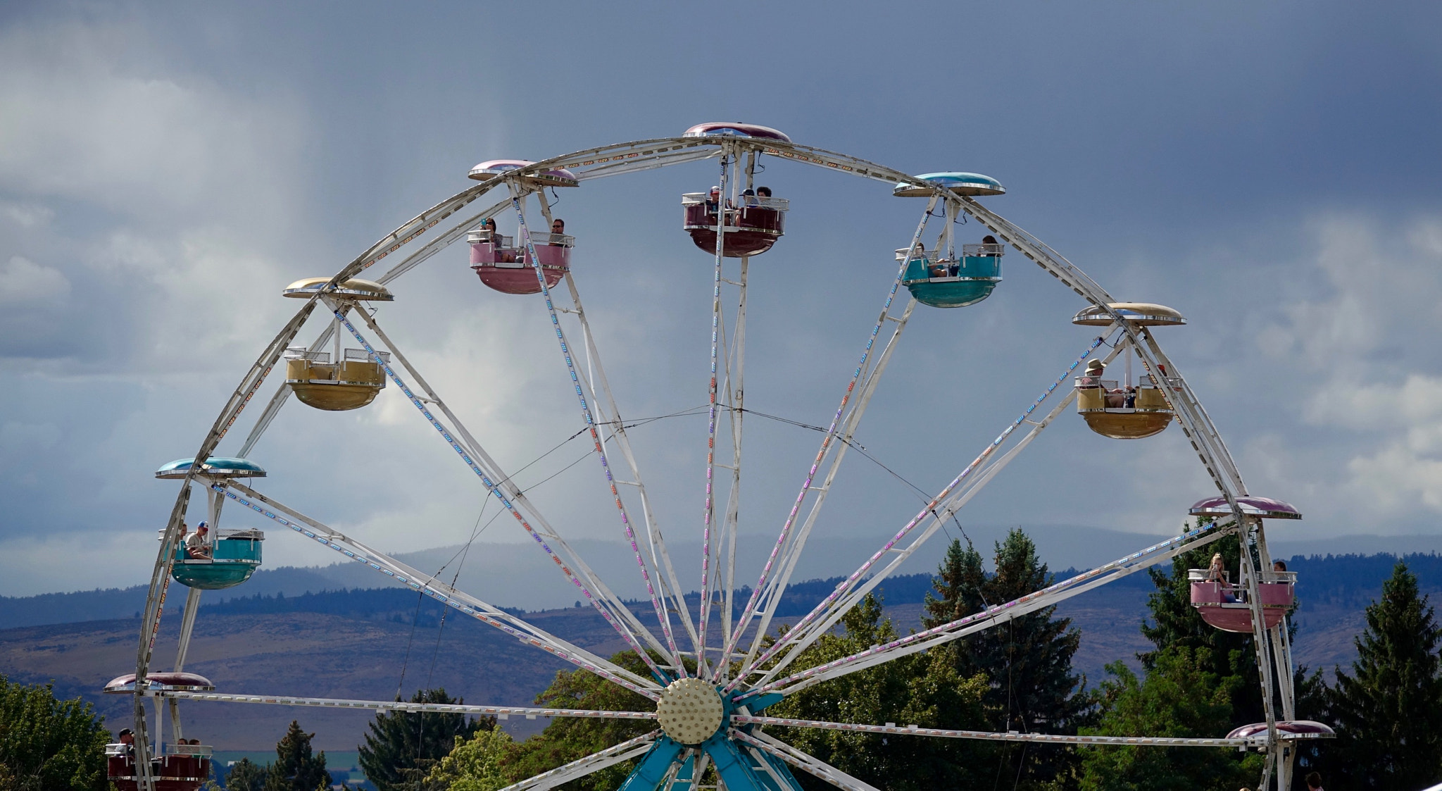 Sony 24-600mm F2.4-4.0 sample photo. Watching the rodeo, rain threatening photography