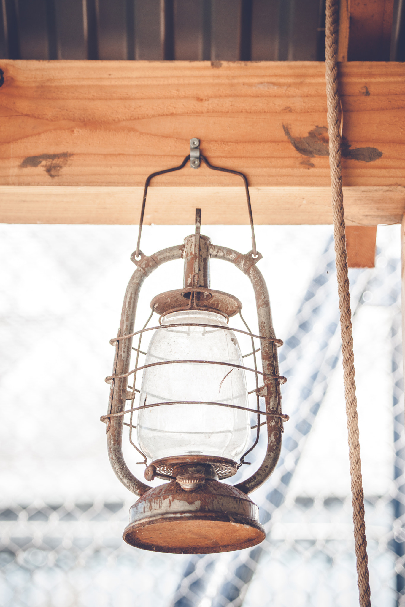 Sony 70-400mm F4-5.6 G SSM II sample photo. Vintage western lantern hanging on a wooden plank photography