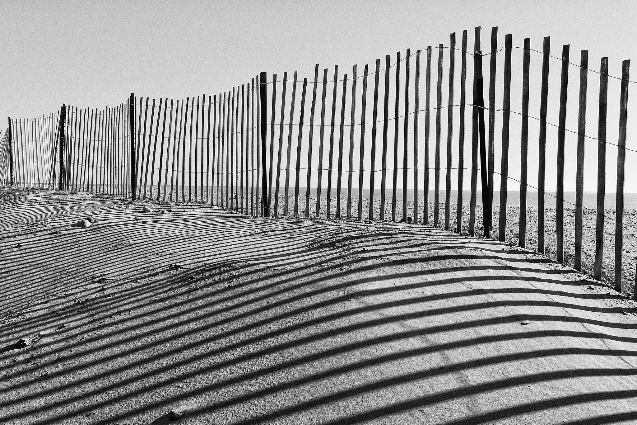 Nikon 1 Nikkor VR 6.7-13mm F3.5-5.6 sample photo. The long shadows of the fence photography