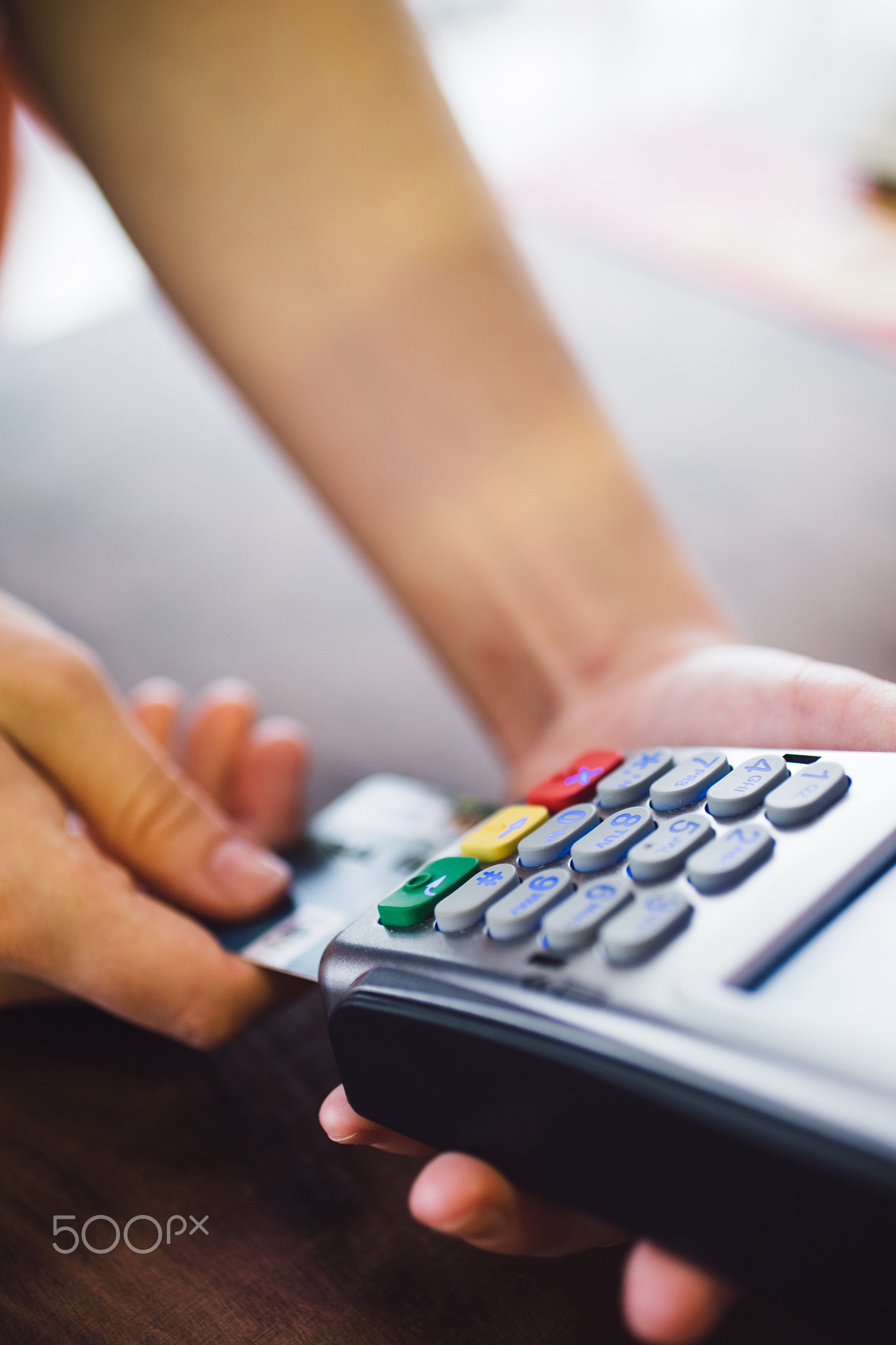 Female hand inserts the credit card into the terminal