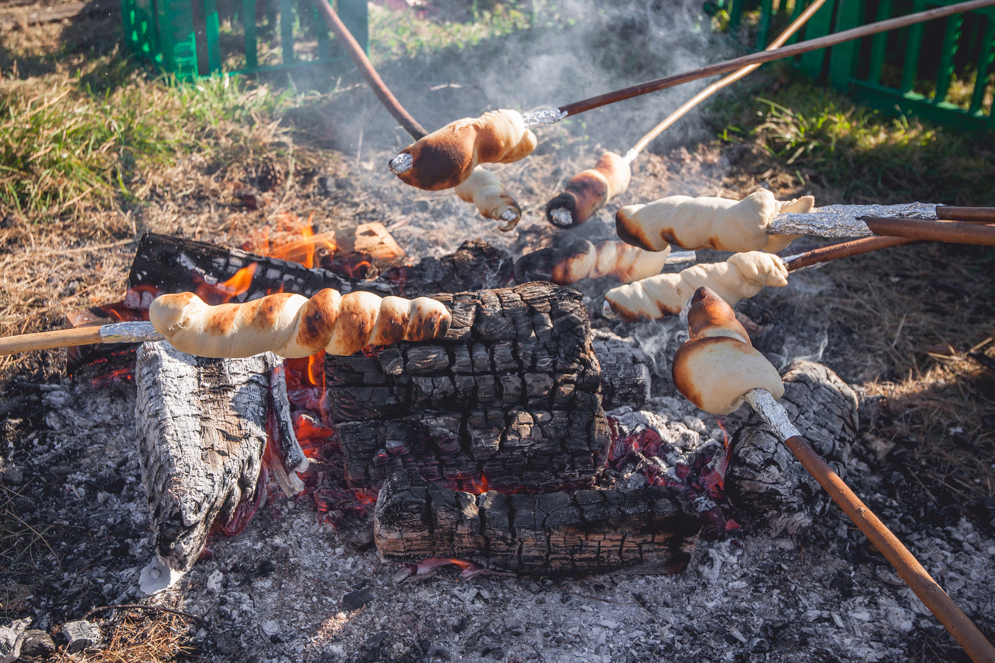 Sony Alpha DSLR-A900 + Sony Vario-Sonnar T* 16-35mm F2.8 ZA SSM sample photo. Bread on sticks over an outdoor campfire photography