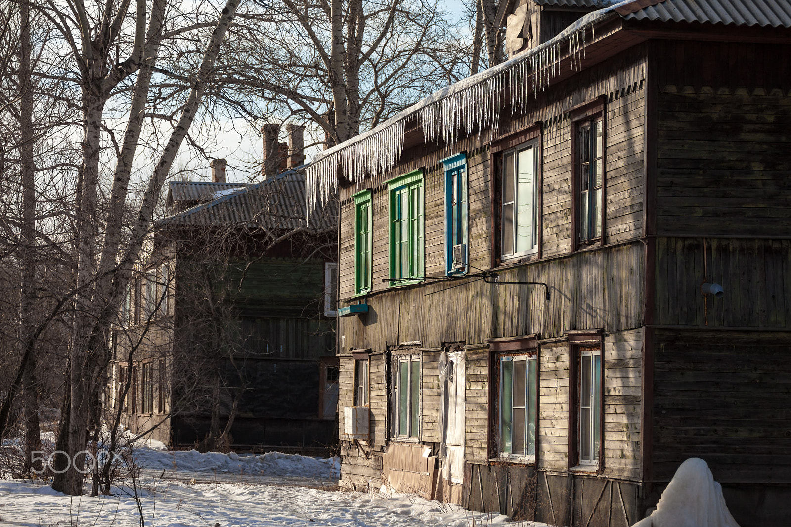 Canon EOS 5D Mark II sample photo. Icicles hanging down from the roof of an old house photography
