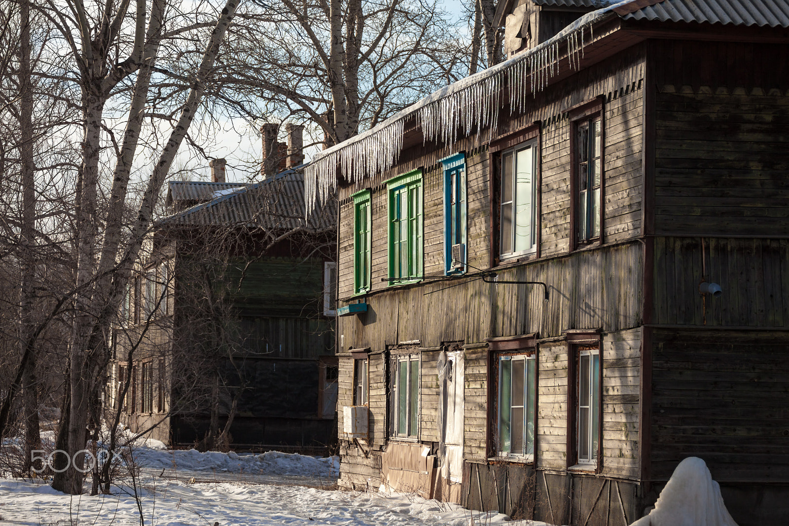 Canon EF 100-300mm f/5.6L sample photo. Icicles hanging down from the roof of an old house photography