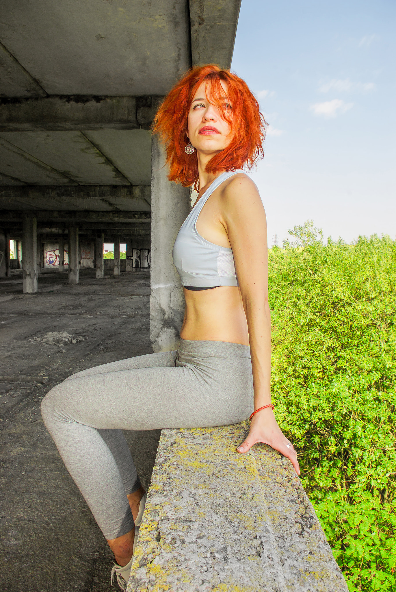 Pentax K200D sample photo. Girl with red hair sitting on the edge of the window in an aband photography