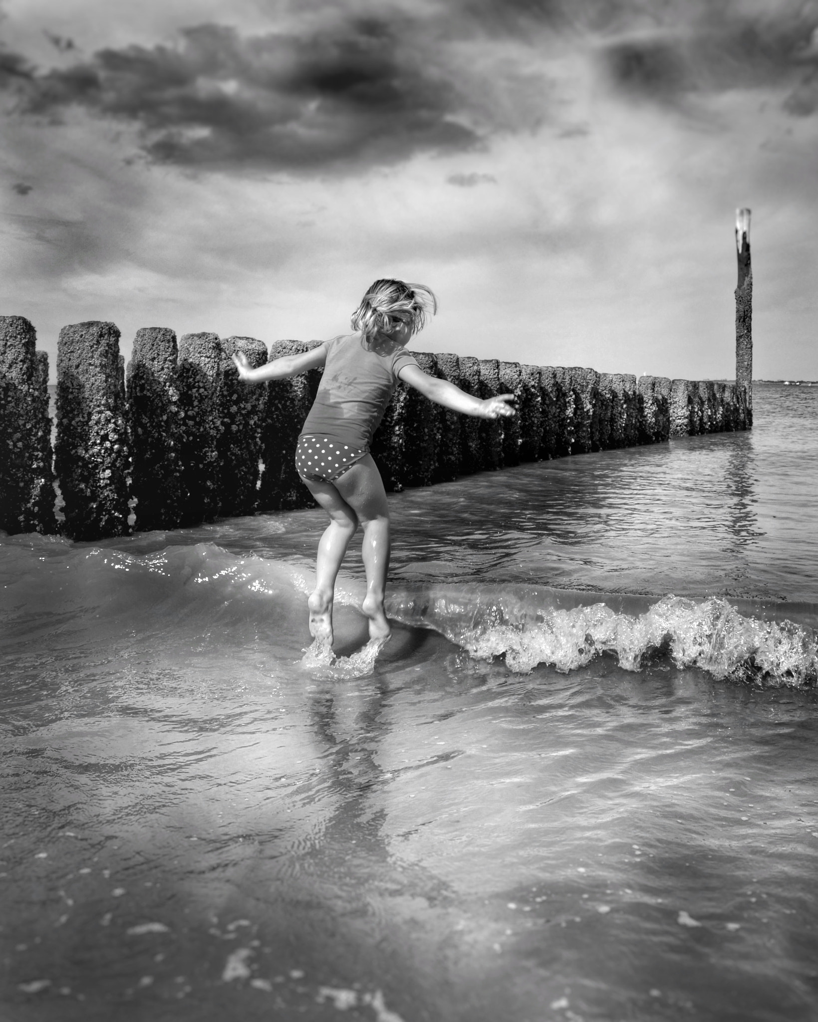 Sigma 28-300mm F3.5-6.3 DG Macro sample photo. Jumping over the waves bnw photography