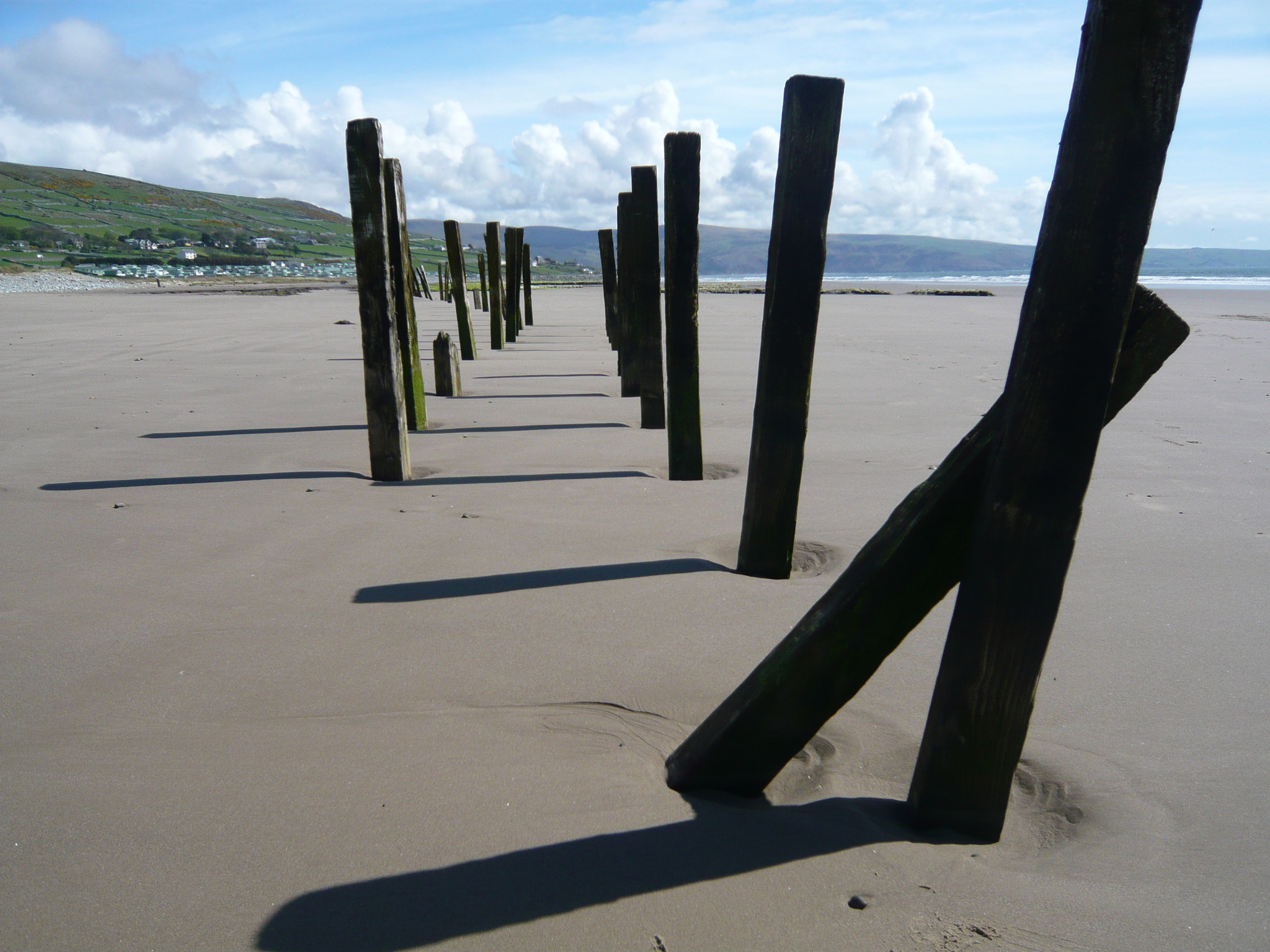 Panasonic DMC-FX33 sample photo. Wooden poles on beach in wales photography