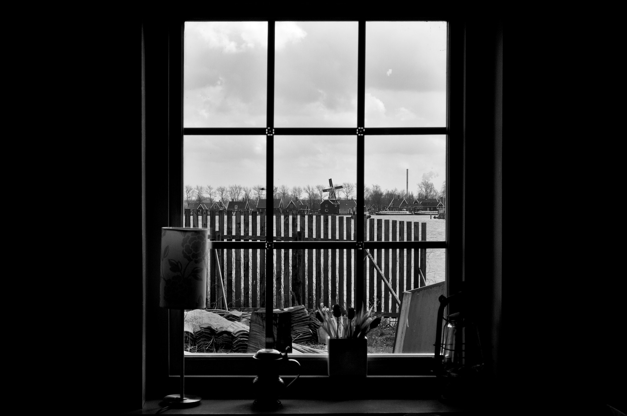 Sigma 17-70mm F2.8-4 DC Macro OS HSM sample photo. A windmill through a window, framed. photography