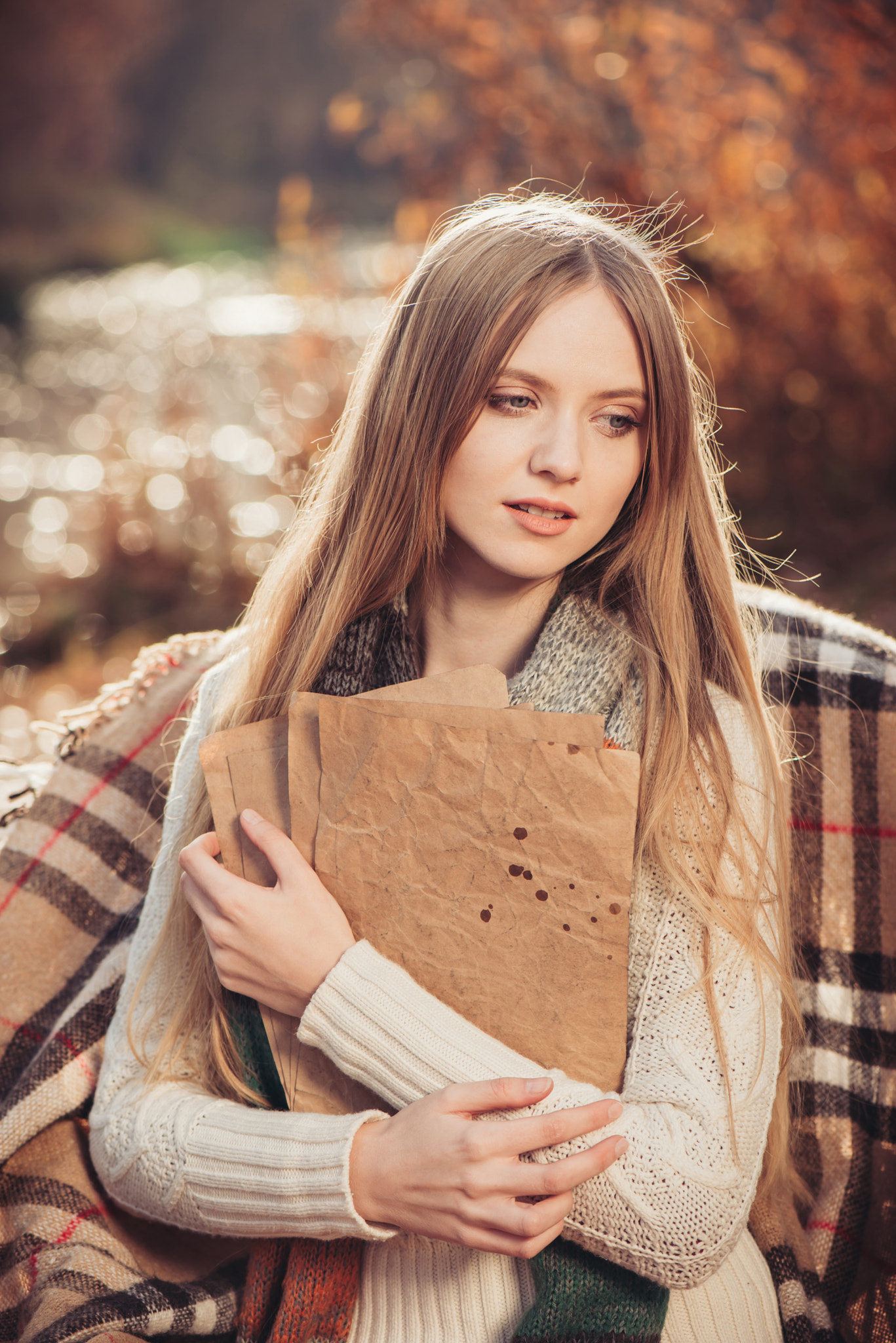Beautiful young woman in white knitted sweater