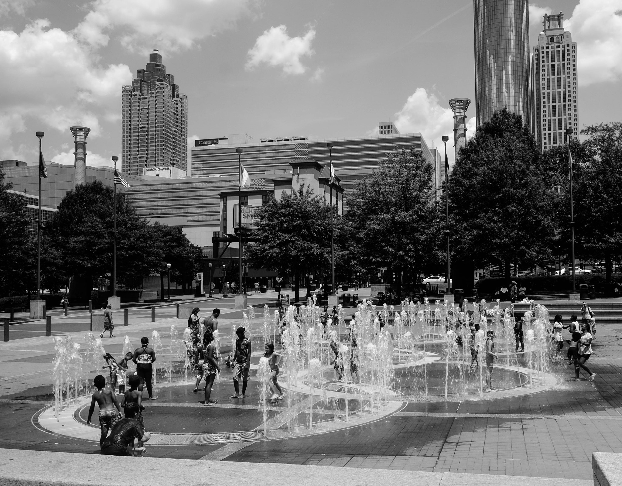 Sony Alpha NEX-6 + Sony E PZ 18-105mm F4 G OSS sample photo. Kids play in fountain on hot summer day photography