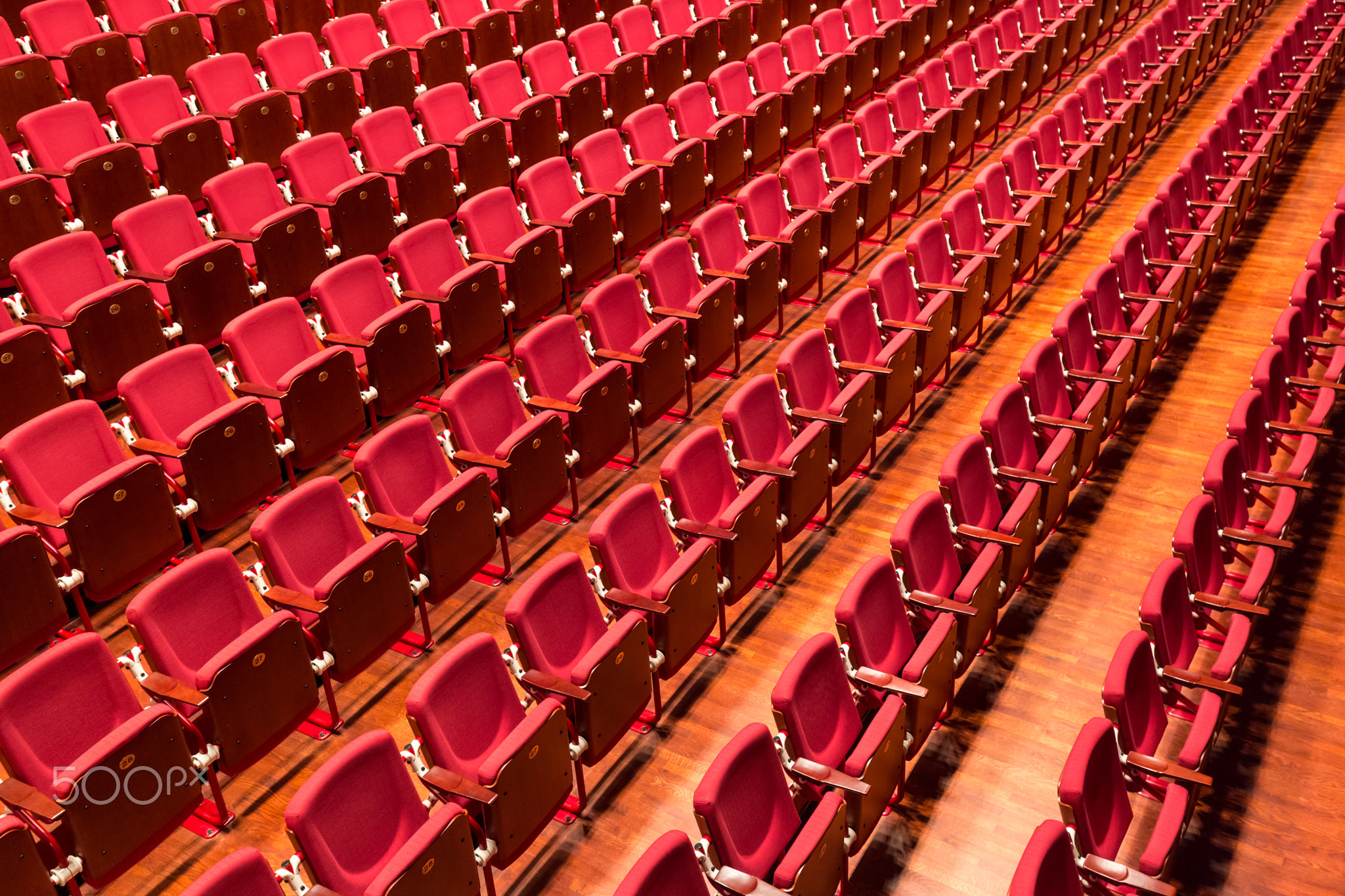 Red color theatre chair in conference room.