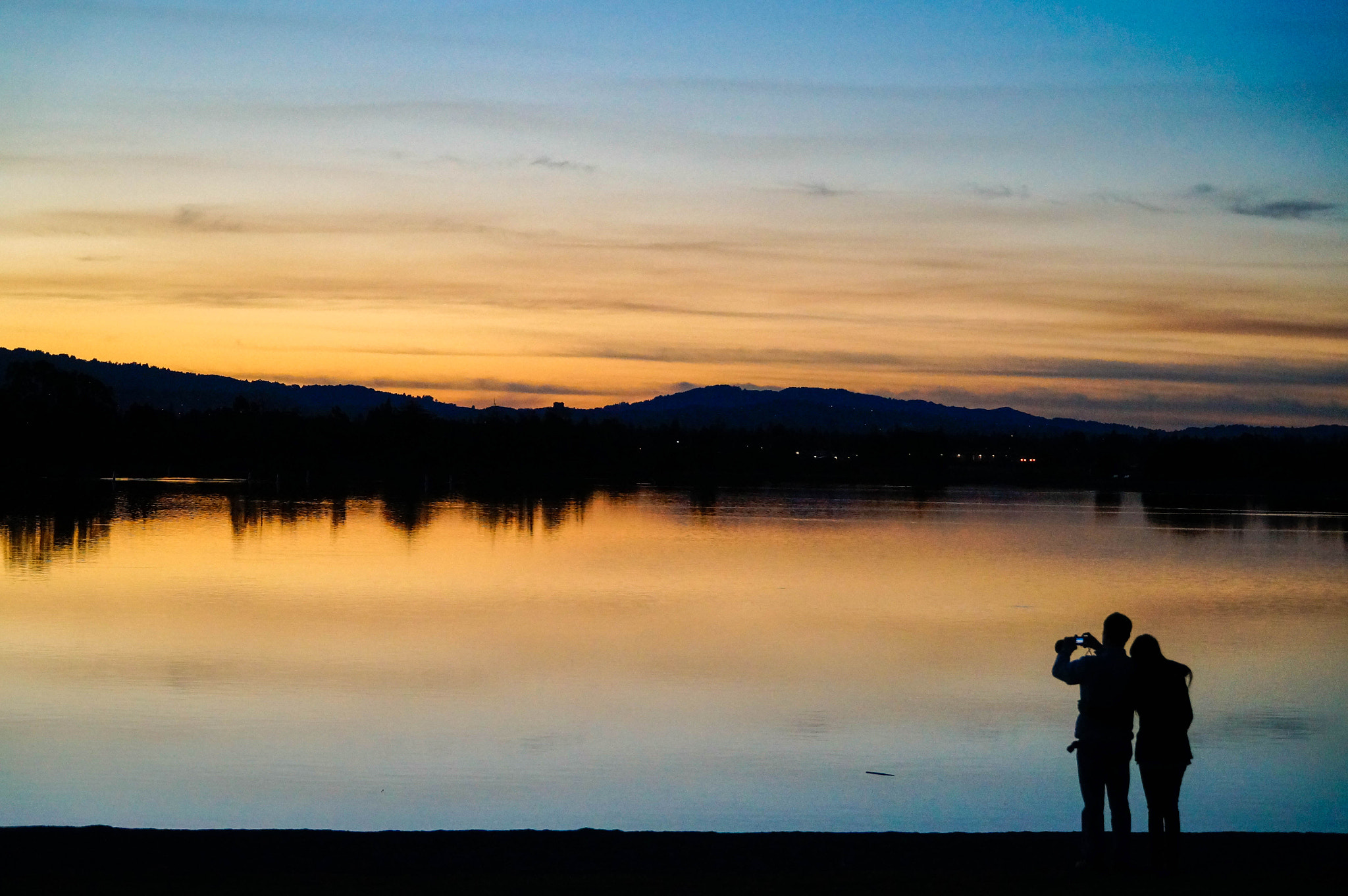 Sony Alpha NEX-6 + Sony E PZ 18-105mm F4 G OSS sample photo. Couple enjoying sunset together photography