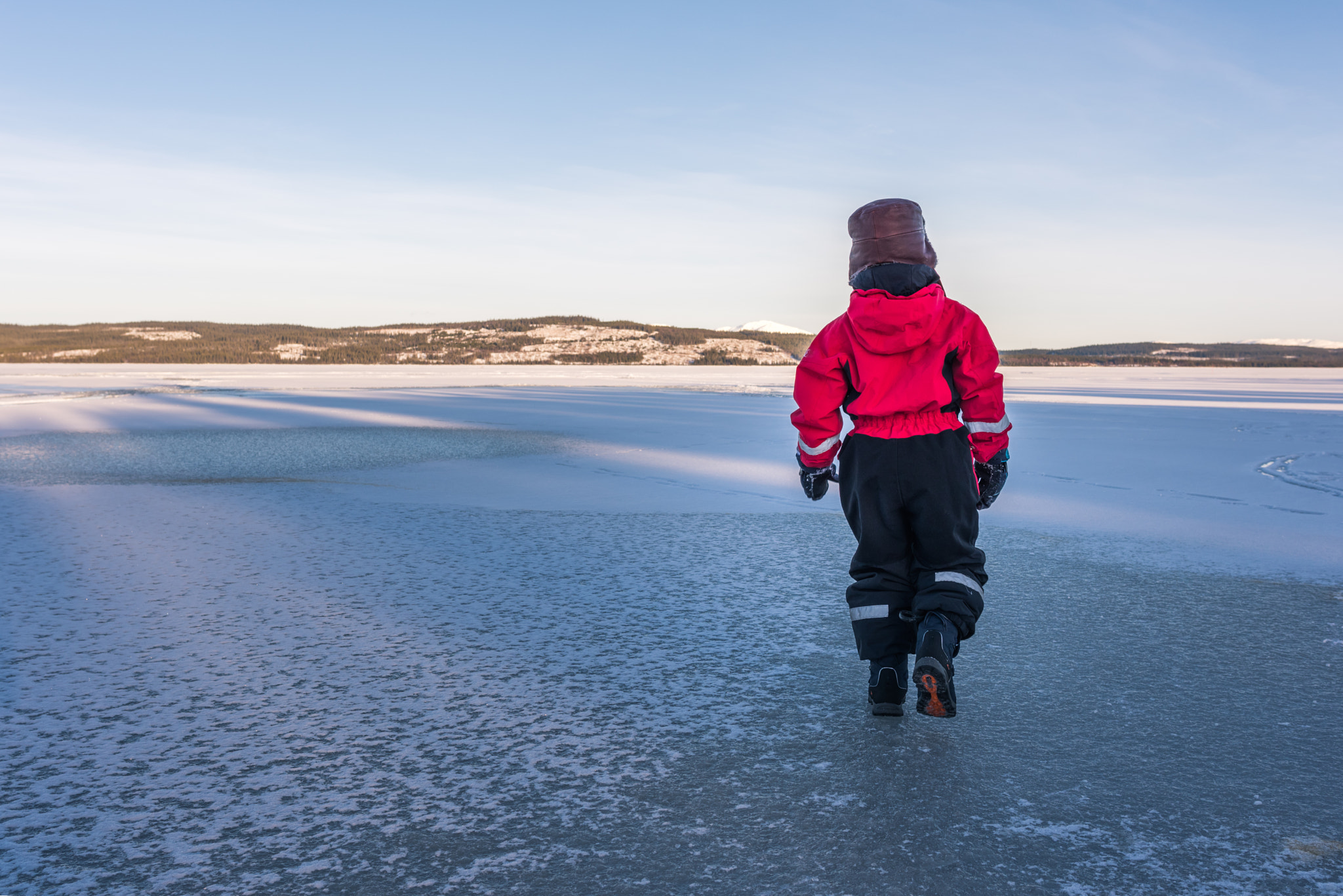 Nikon D810 + Nikon AF-S Nikkor 28mm F1.8G sample photo. Child walking on frozen lake. photography