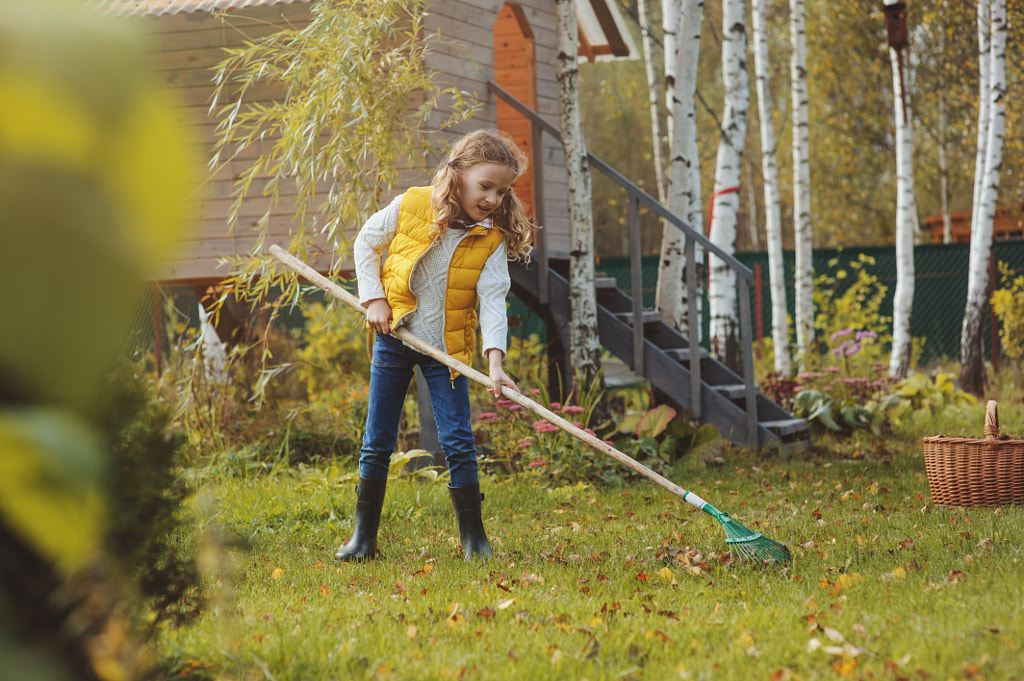 happy child girl playing little gardener in autumn and picking leaves by Maria Kovalevskaya on 500px.com