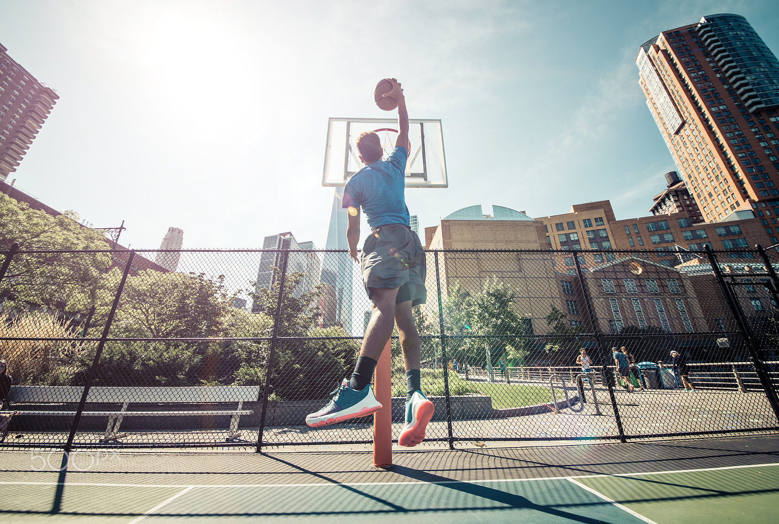 Nikon D610 + Sigma 12-24mm F4.5-5.6 II DG HSM sample photo. Street basketball athlete performing huge slam dunk on the court photography