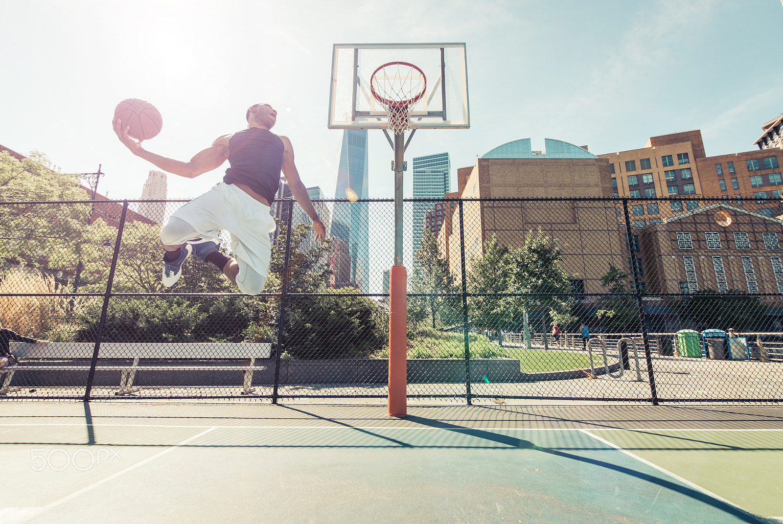 Nikon D610 + Sigma 12-24mm F4.5-5.6 II DG HSM sample photo. Street basketball athlete performing huge slam dunk on the court photography