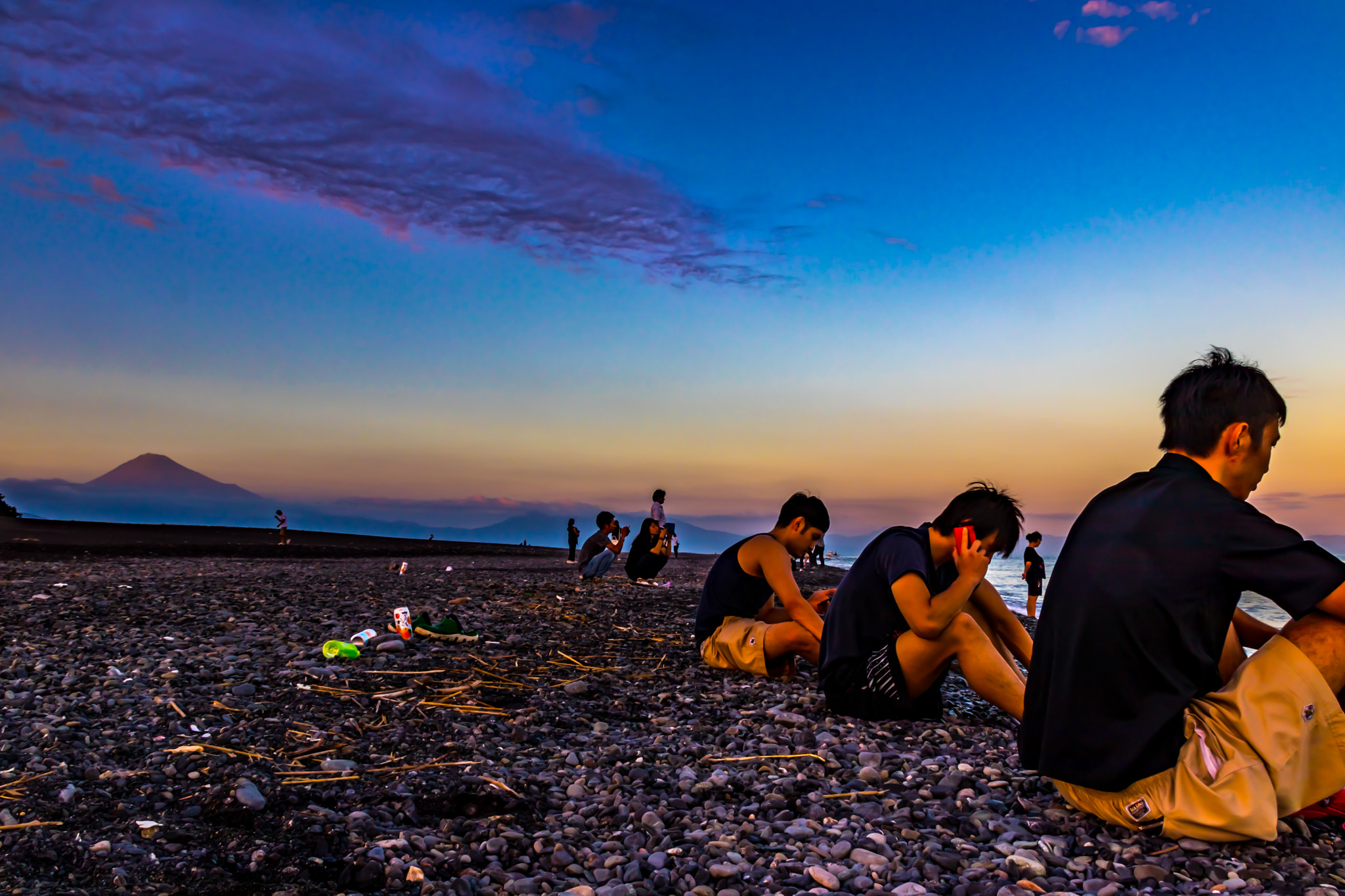 Canon EF 75-300mm F4.0-5.6 IS USM sample photo. Friends relaxing at beach talking on phone. photography