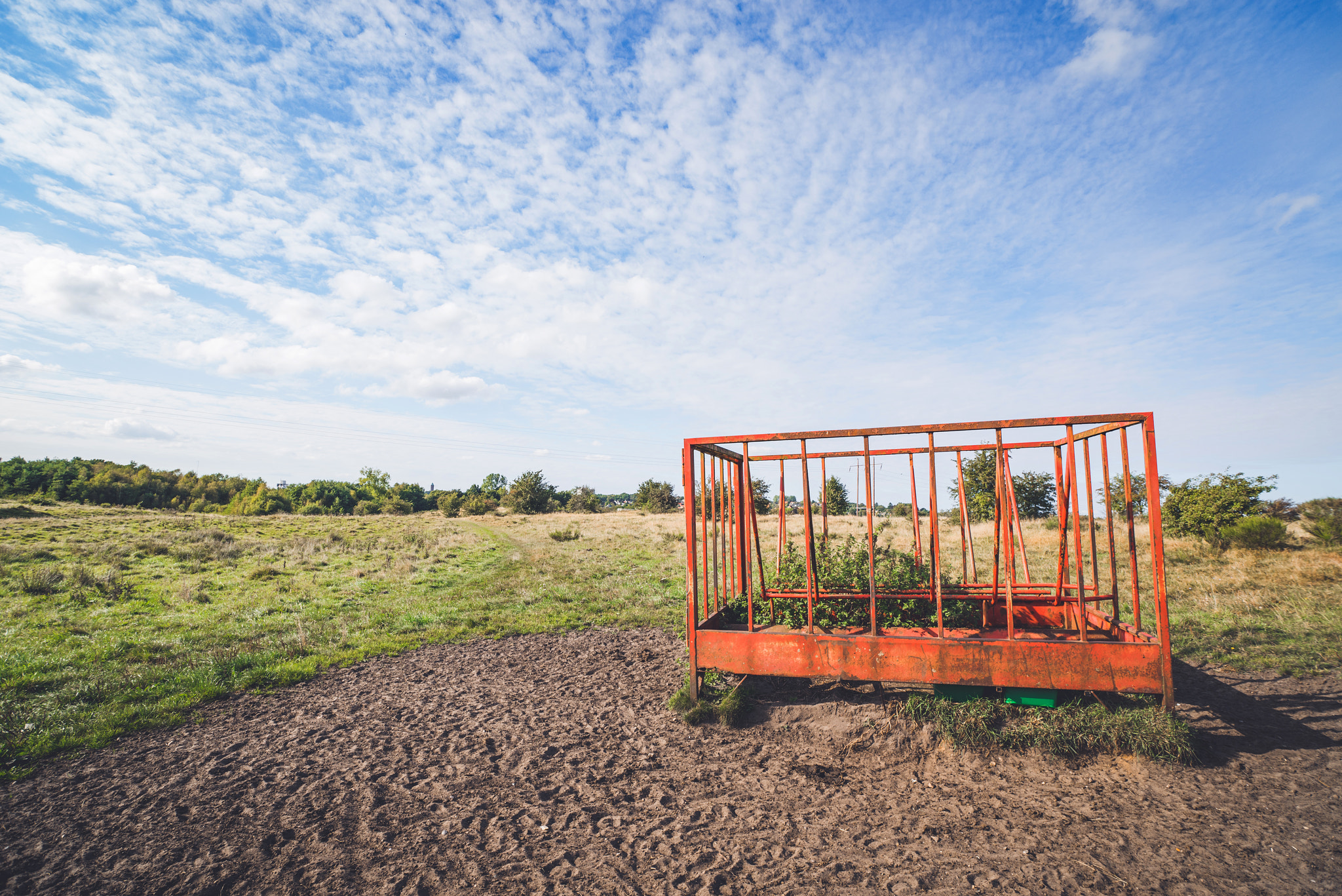 Sony a7R + Sony Vario-Sonnar T* 16-35mm F2.8 ZA SSM sample photo. Rural landscape with a cage on a field photography