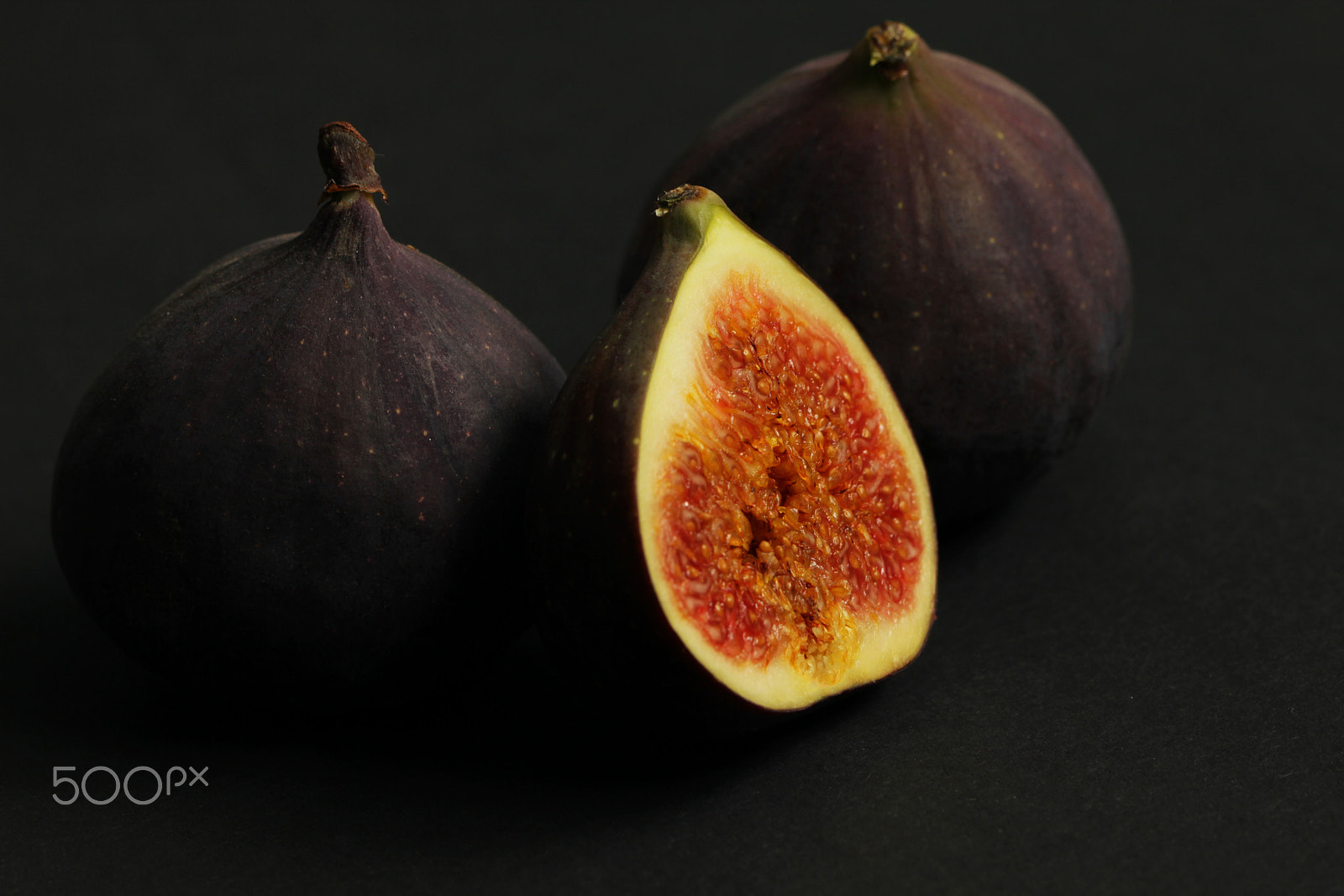 Canon EOS 550D (EOS Rebel T2i / EOS Kiss X4) + Canon EF 100mm F2.8L Macro IS USM sample photo. Fresh figs isolated on black photography