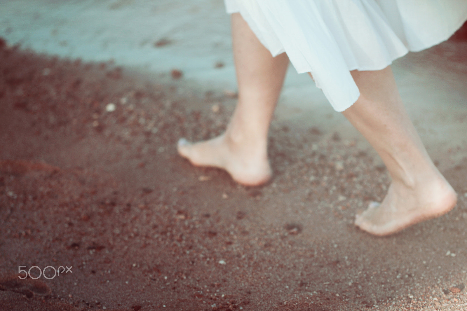 Canon EOS 550D (EOS Rebel T2i / EOS Kiss X4) + Canon EF 100mm F2.8L Macro IS USM sample photo. Young woman in white dress walking alone on the beach photography