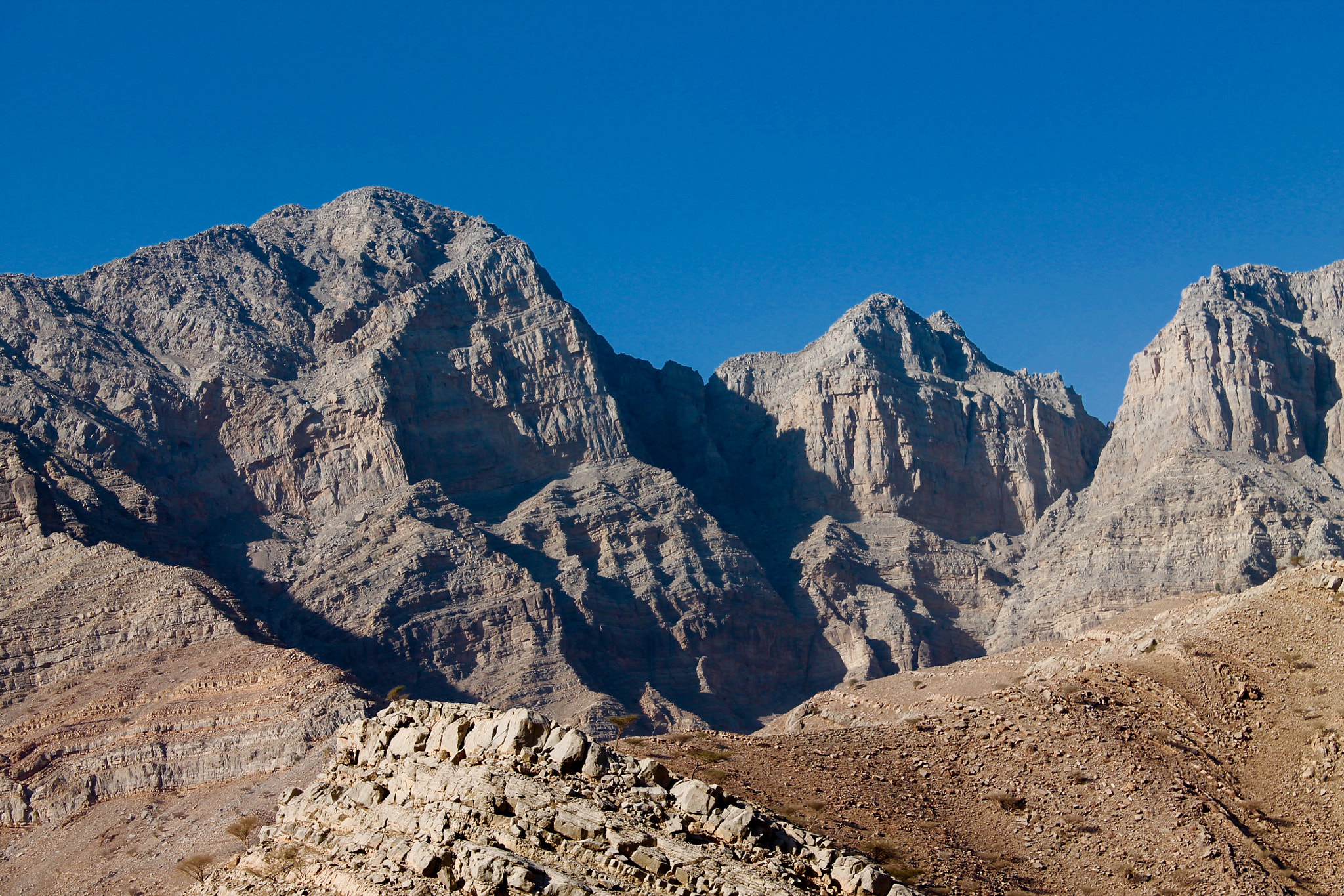 Canon EF-S 18-55mm F3.5-5.6 III sample photo. Harsh jagged mountains set against clear deep blue sky photography