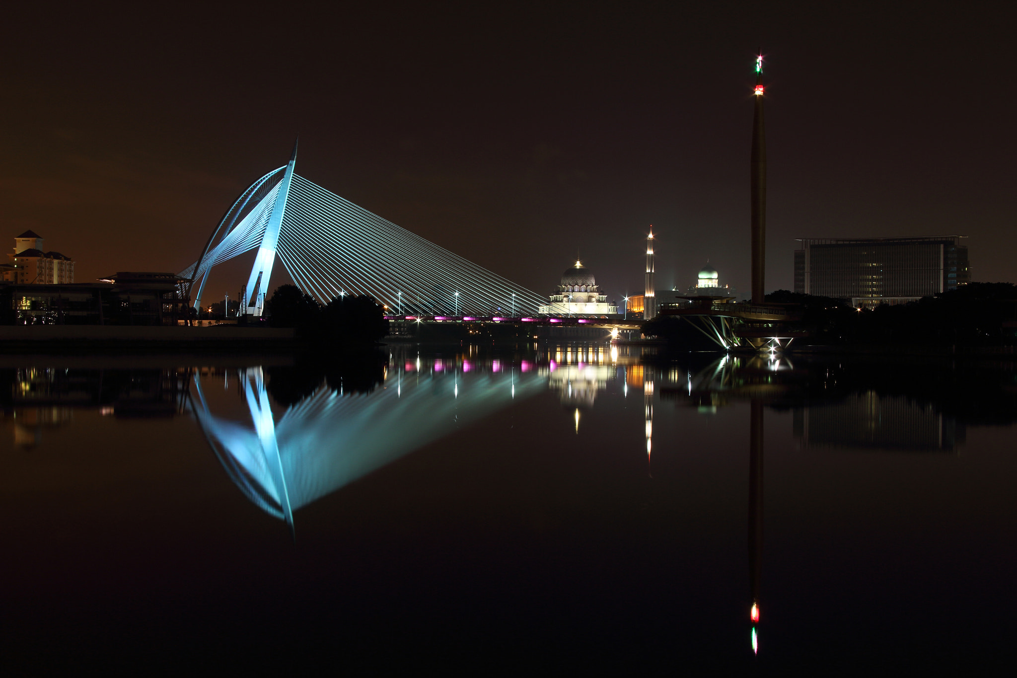 Canon EF 28-135mm F3.5-5.6 IS USM sample photo. The seri wawasan bridge putrajaya at night with its reflection on the lake water photography