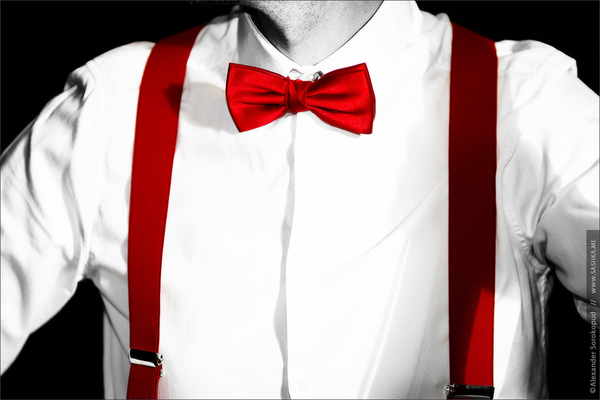 Sony a99 II sample photo. Conceptual costume. red bow-tie and braces. jazzbow on white shi photography