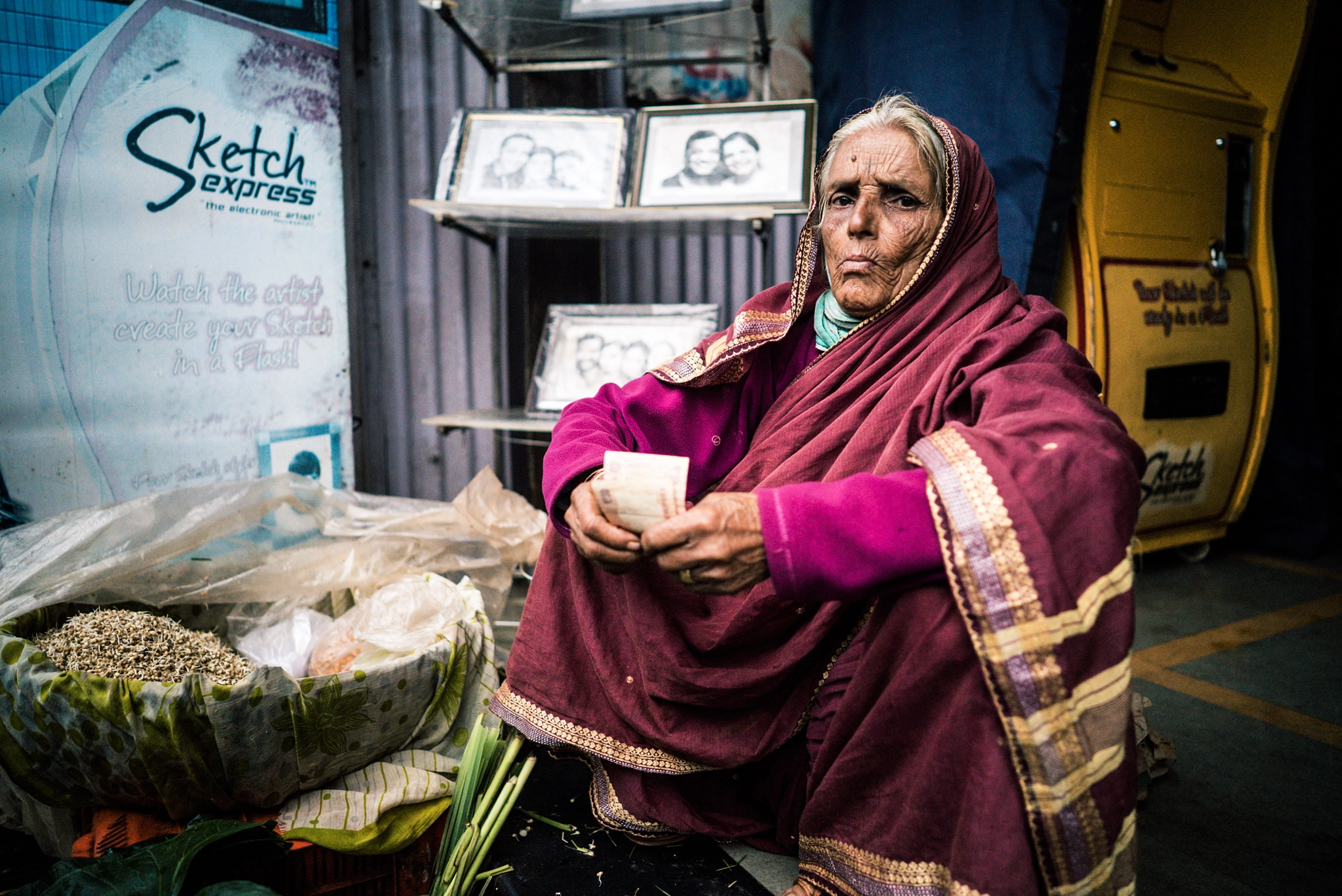 ZEISS Batis 25mm F2 sample photo. Women takes money change and gives a pose photography