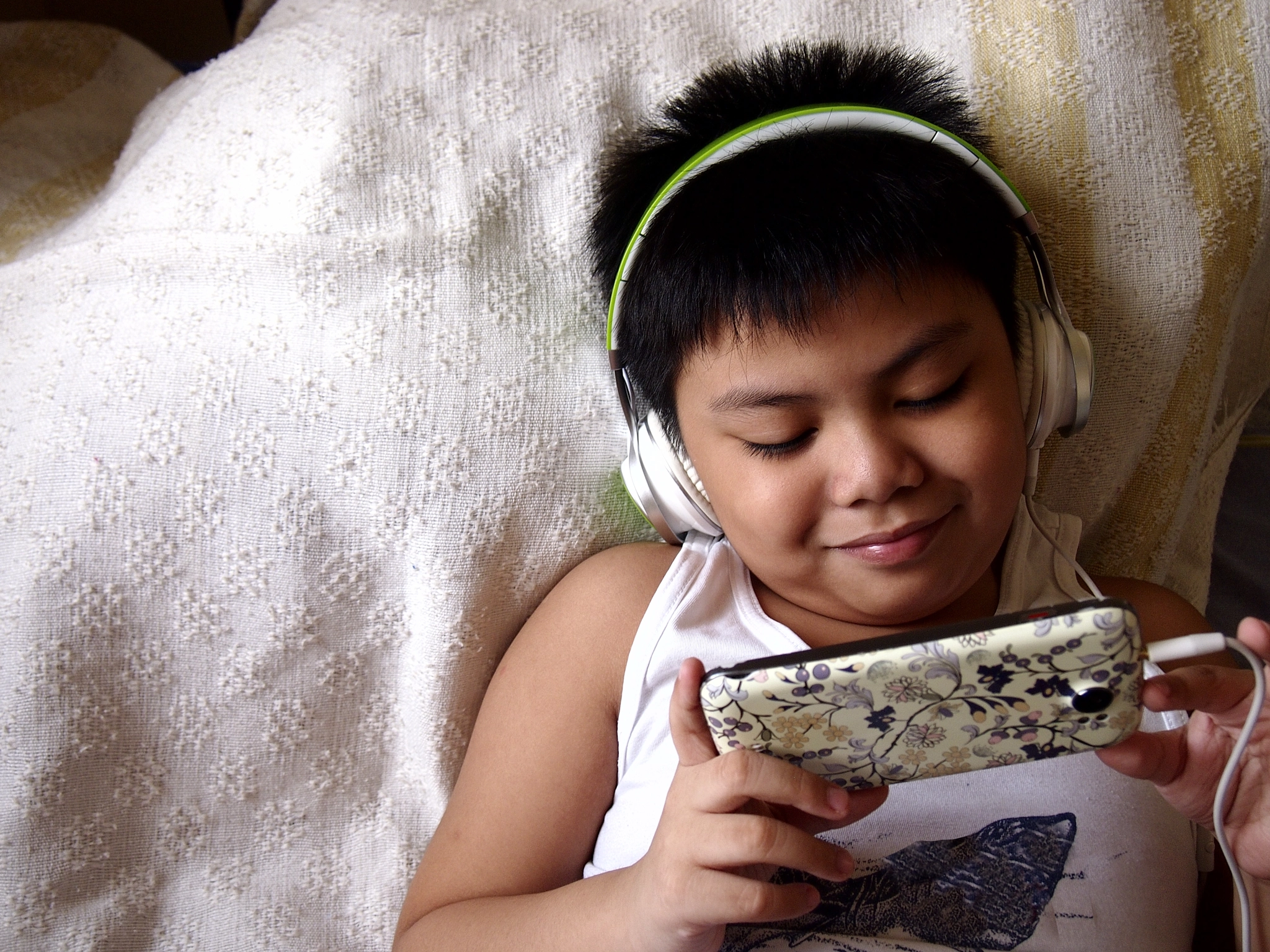 Young, boy with headphones and smartphone