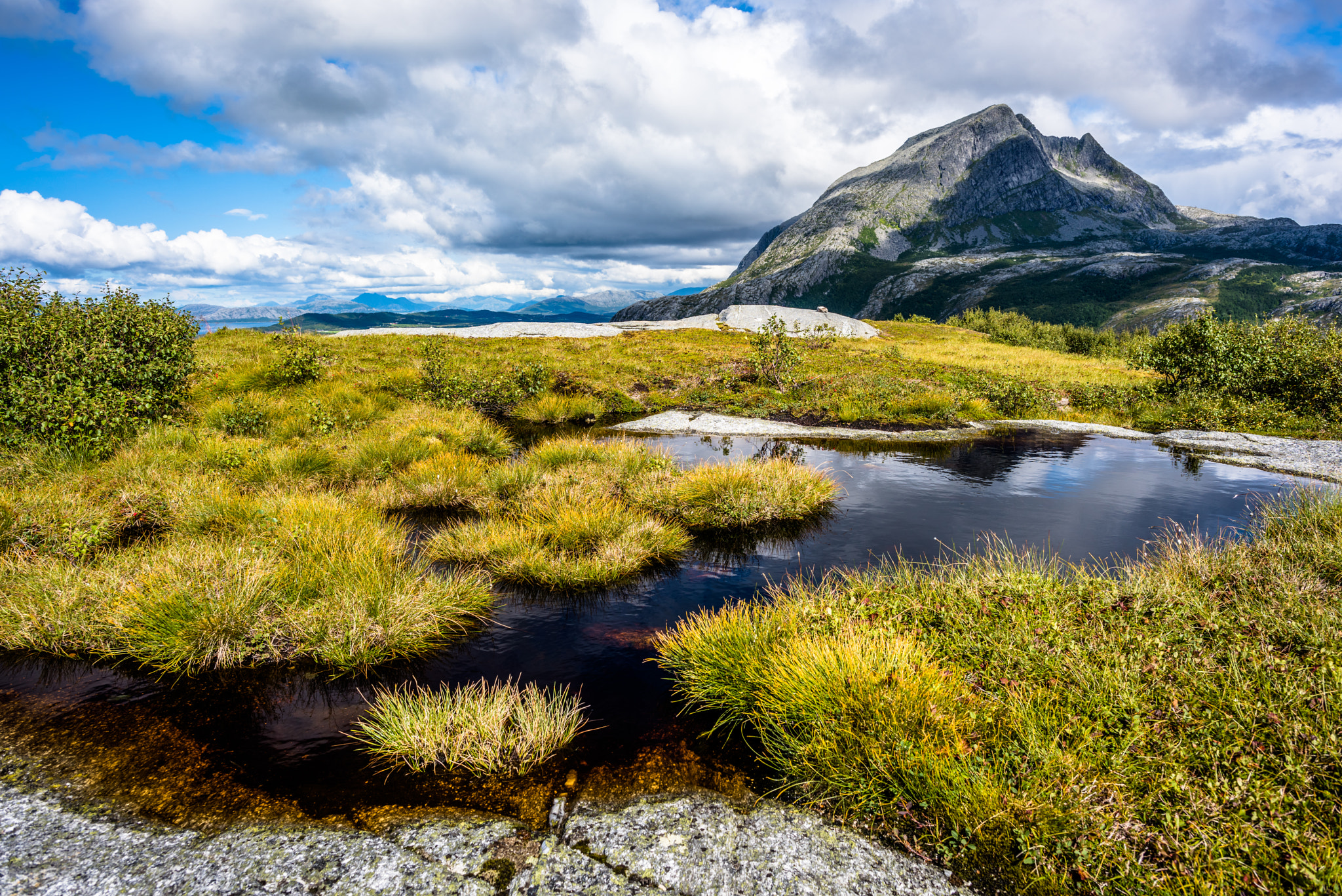 Nikon D810 + Nikon AF-S Nikkor 24mm F1.4G ED sample photo. Small grassy pond in mountain photography