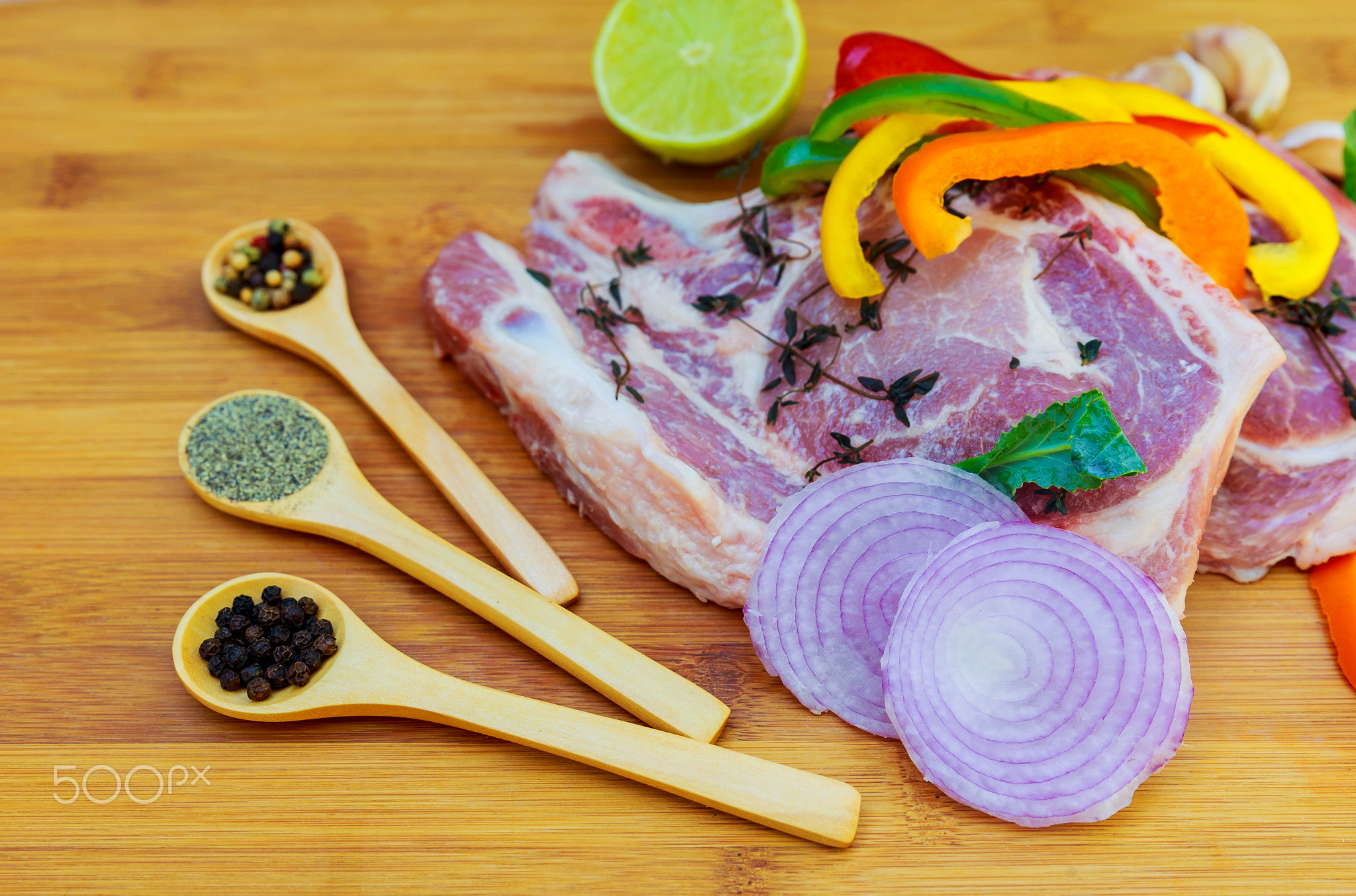 Raw meat steaks with spices cutting board.