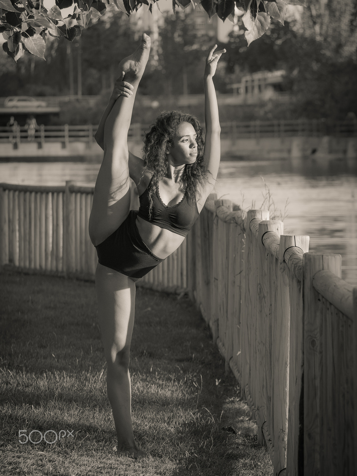 Panasonic Lumix DMC-GH3 sample photo. Latin dancer with leg and arm raised above his head monochrome photography