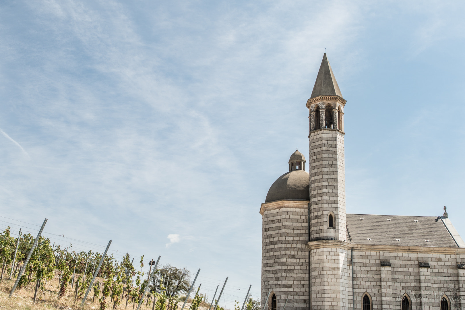 Nikon D500 + Nikon AF-S Nikkor 28mm F1.8G sample photo. A church in france where one can go wine tasting photography