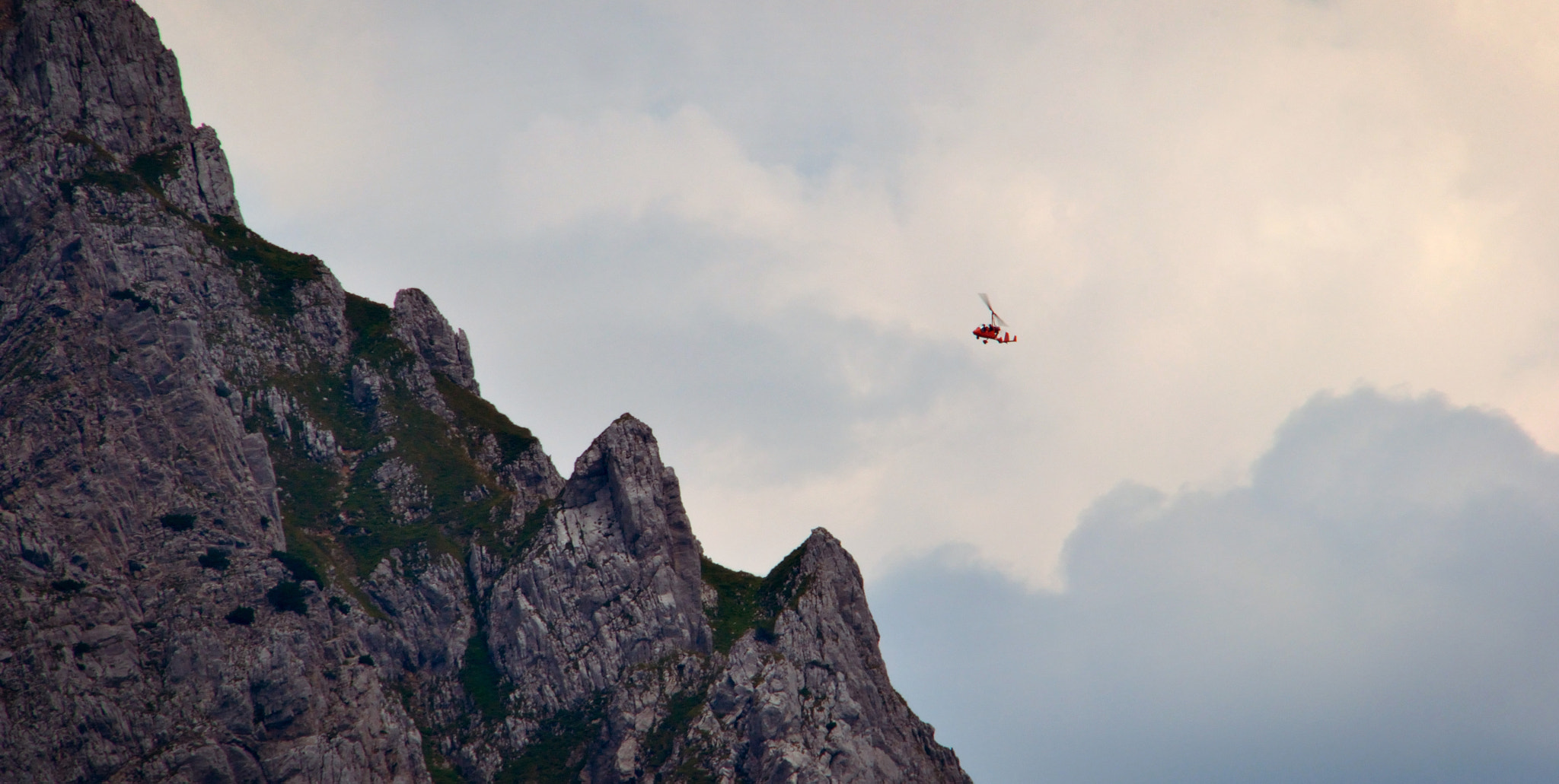 Nikon D3100 + AF Zoom-Nikkor 75-240mm f/4.5-5.6D sample photo. Helicopter facing a mountain photography