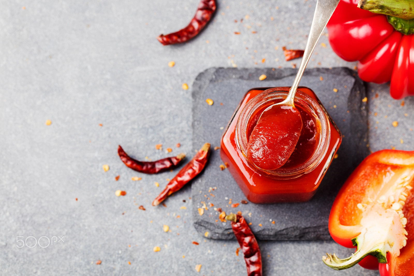 Canon EOS 5DS + Canon EF 100mm F2.8L Macro IS USM sample photo. Sweet bell pepper and chili pepper sauce, confiture, jam in a glass jar. grey stone background.... photography