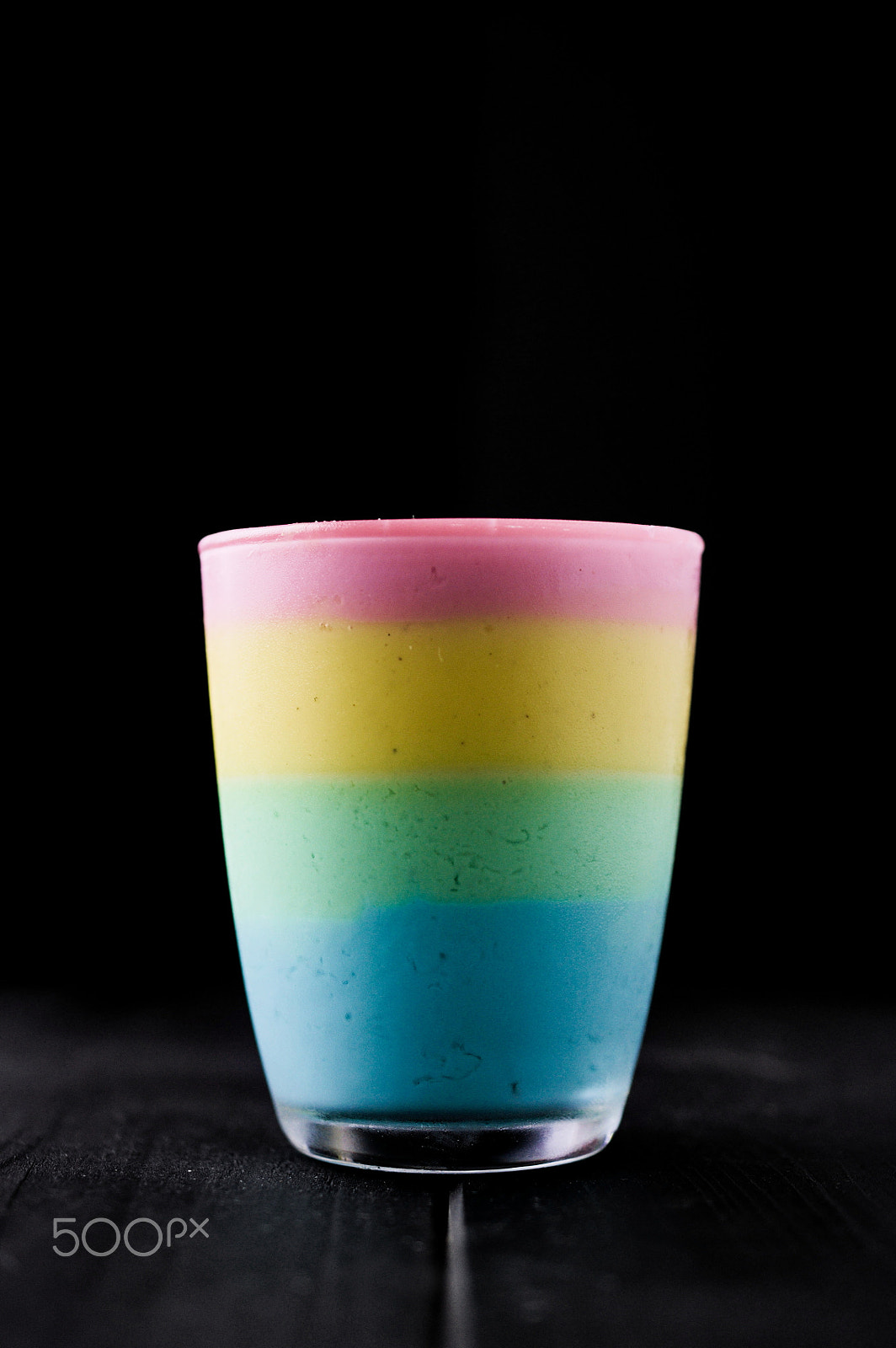 Nikon AF-S DX Micro Nikkor 40mm F2.8 sample photo. The taste of color rainbow pudding in glass on black photography
