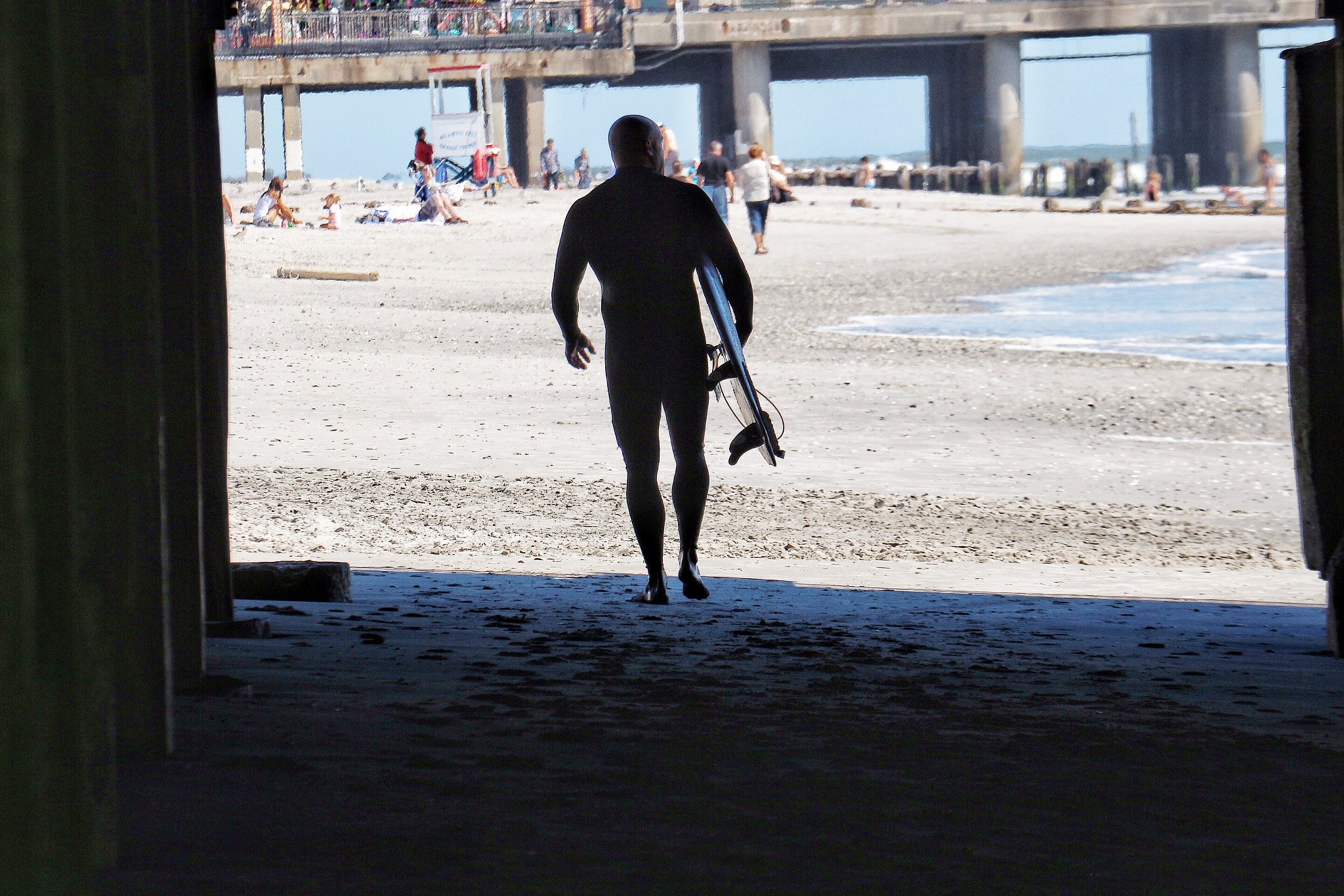 Canon EF 70-300mm F4-5.6L IS USM sample photo. Under the pier, surfer series photography